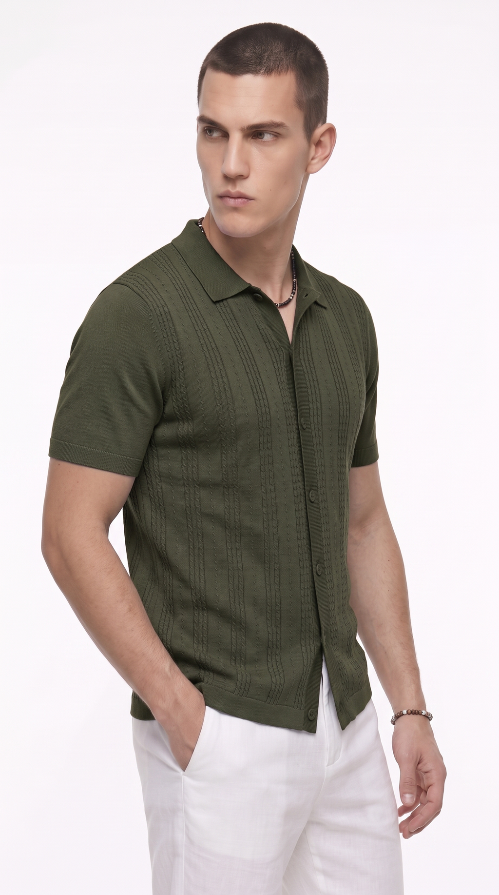 A man wearing a short-sleeve olive green button-up shirt with vertical textured stripes and white pants, photographed against a plain white studio background, from Meleche Fashion USA or Meléche (short as (Mé))