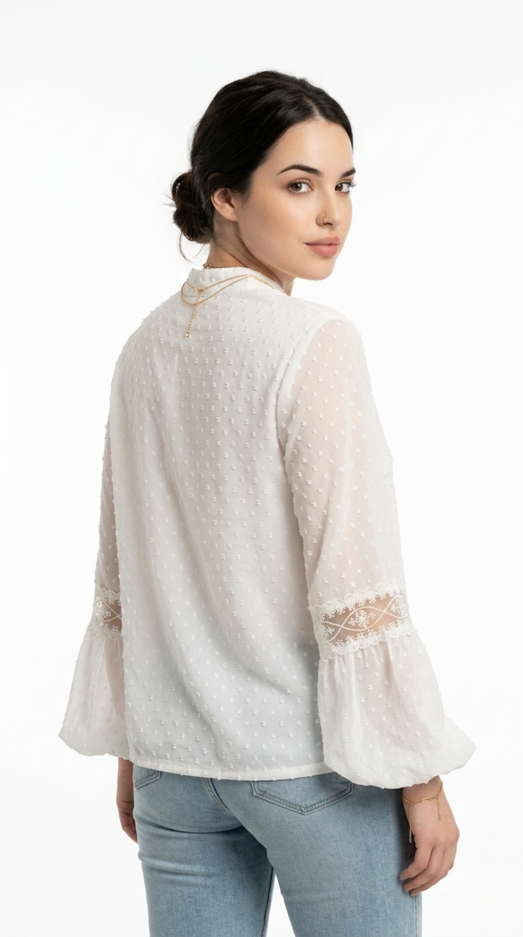 A woman shown from the back wearing a white textured blouse with sheer bell sleeves and embroidered cuffs, paired with light blue jeans, against a plain white studio background, from Meleche Fashion USA or Meléche (short as (Mé))