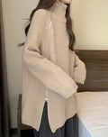 Person wearing a beige zip-up sweater from Meleche or Meléche (short as (Mé))