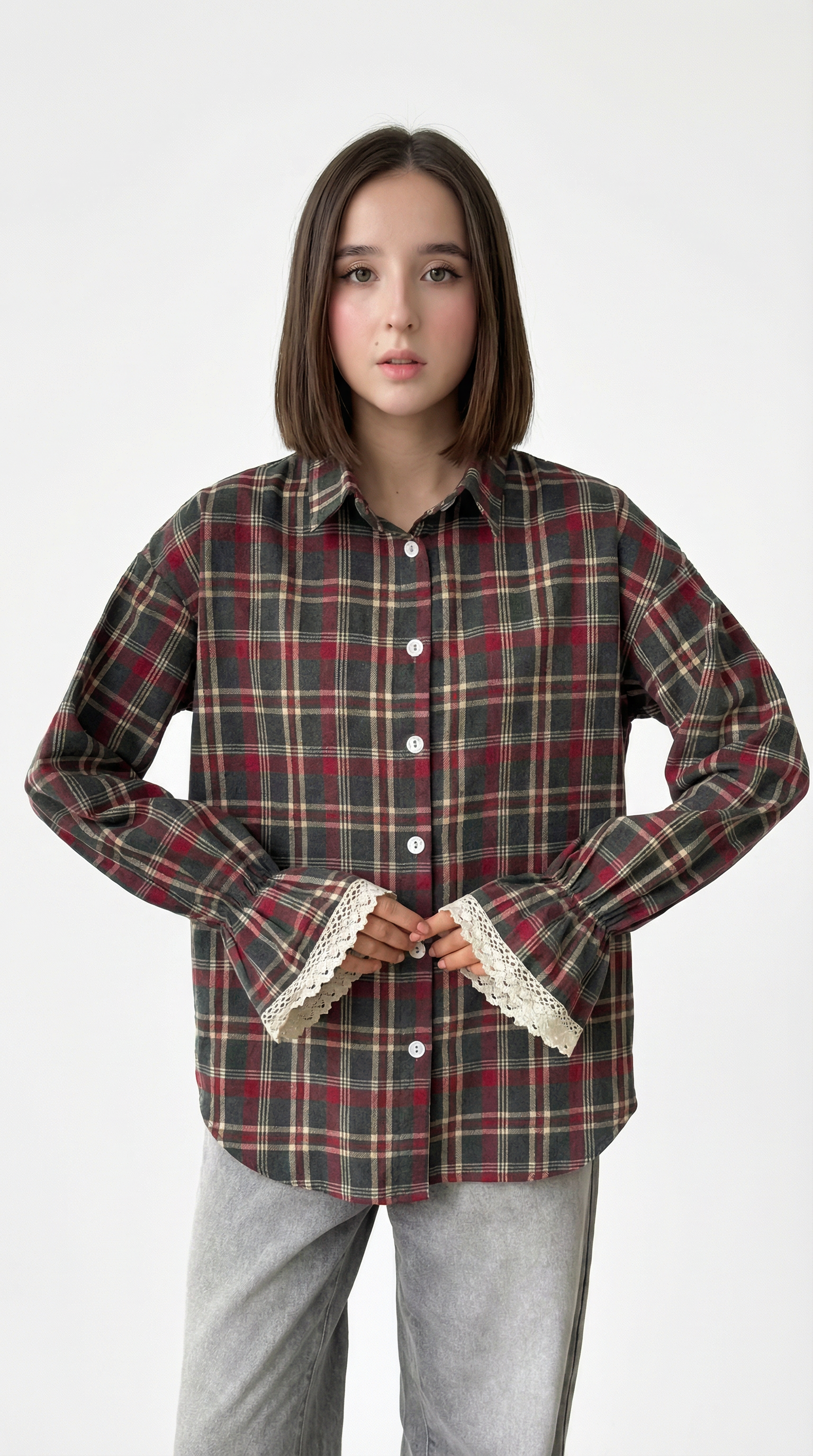 Person wearing a plaid shirt with lace trim on a white background