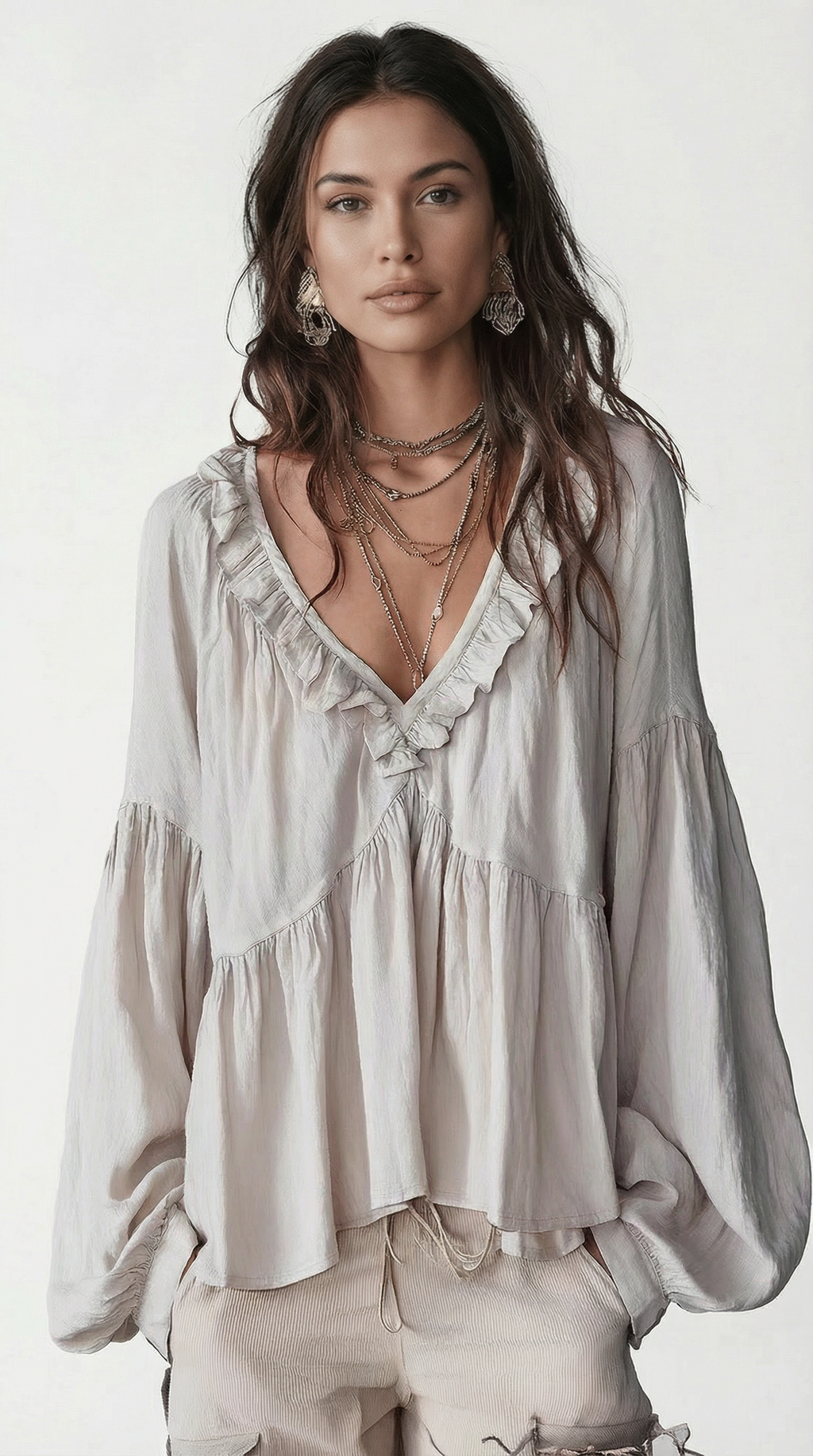 Woman wearing a light blouse with ruffled details on a white background from Meleche Fashion USA or Meléche (short as (Mé))