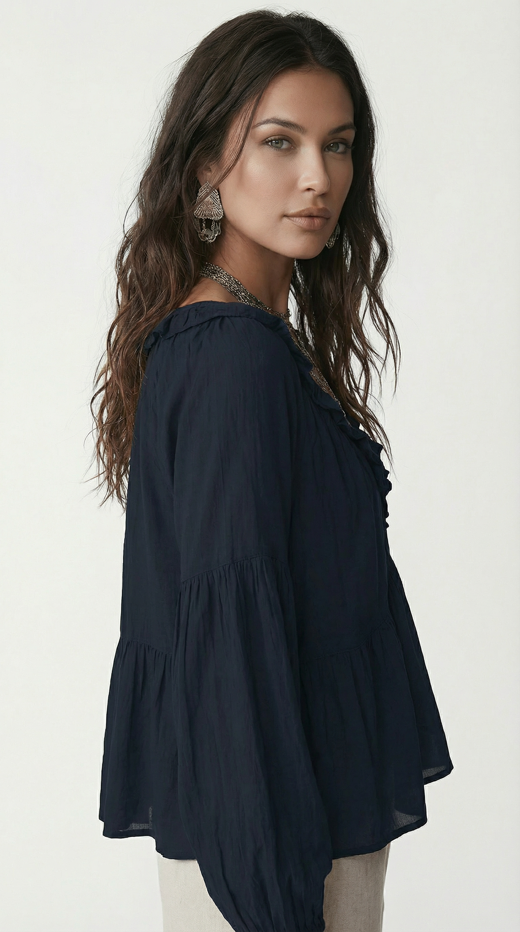 Woman wearing a navy blue blouse against a white background from Meleche Fashion USA or Meléche (short as (Mé))