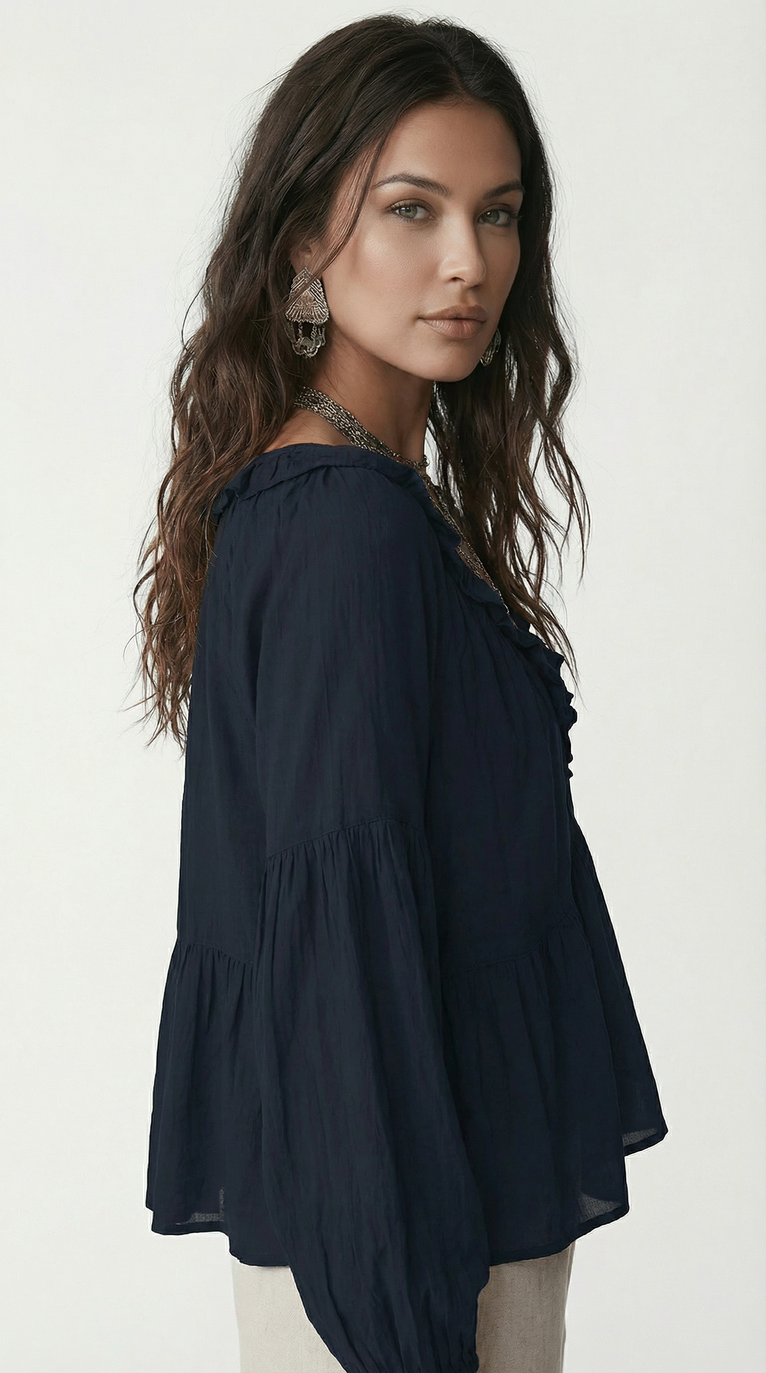 Woman wearing a navy blue blouse against a white background