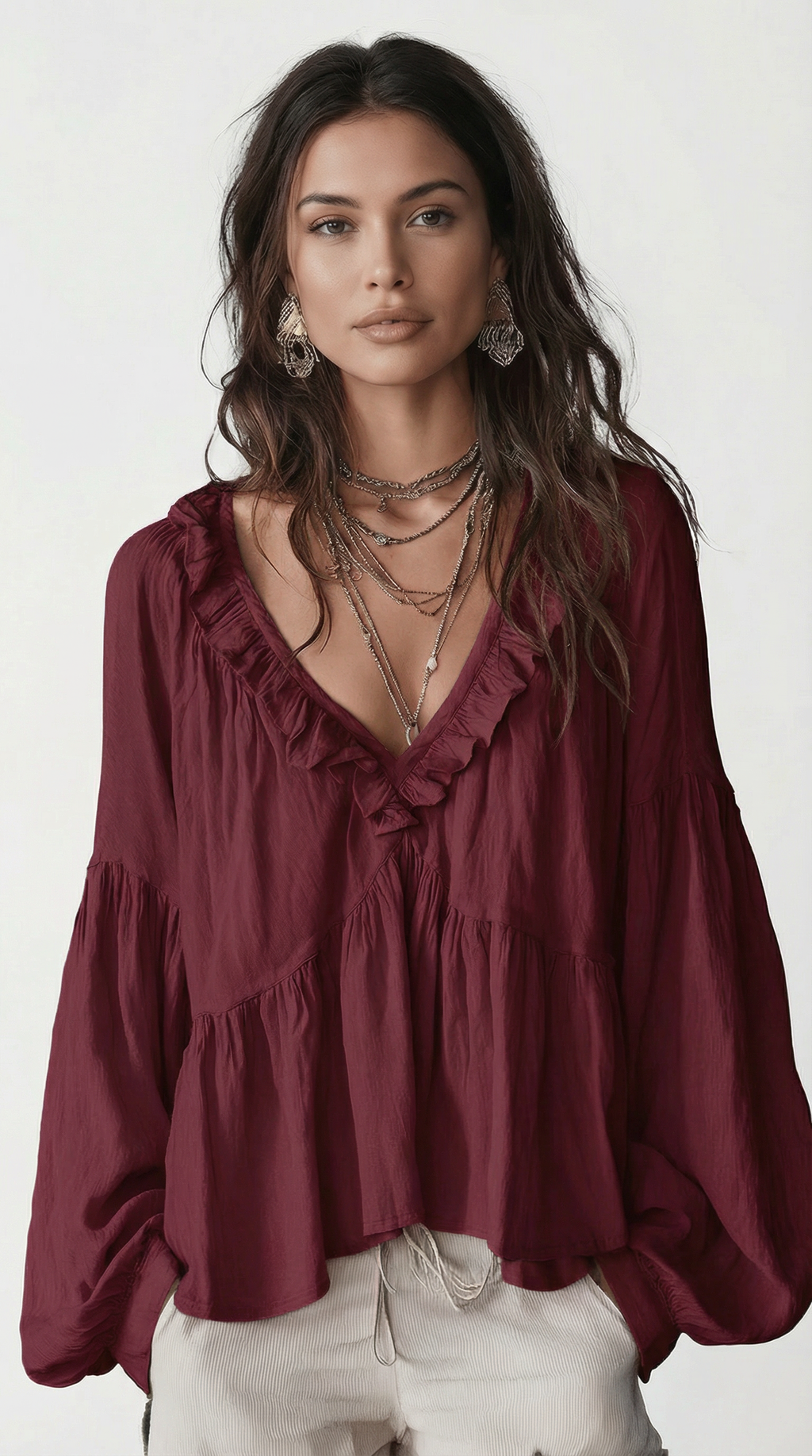 Woman wearing a burgundy blouse with ruffled details on a white background from Meleche Fashion USA or Meléche (short as (Mé))