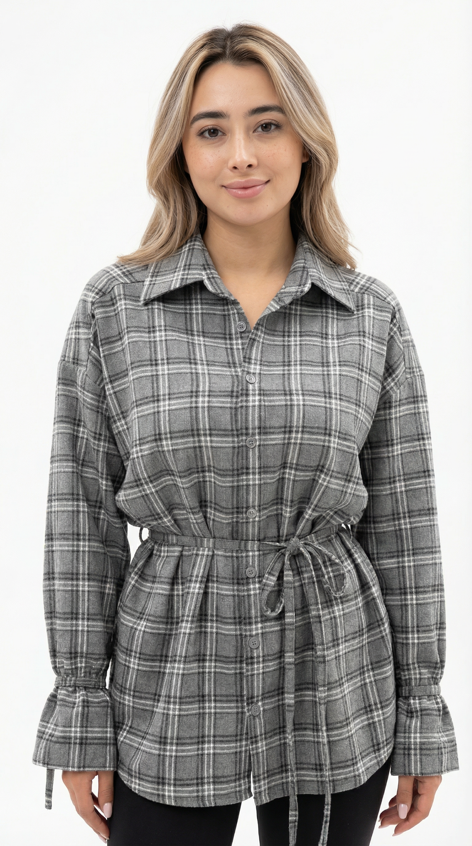 Woman wearing a plaid shirt dress on a white background