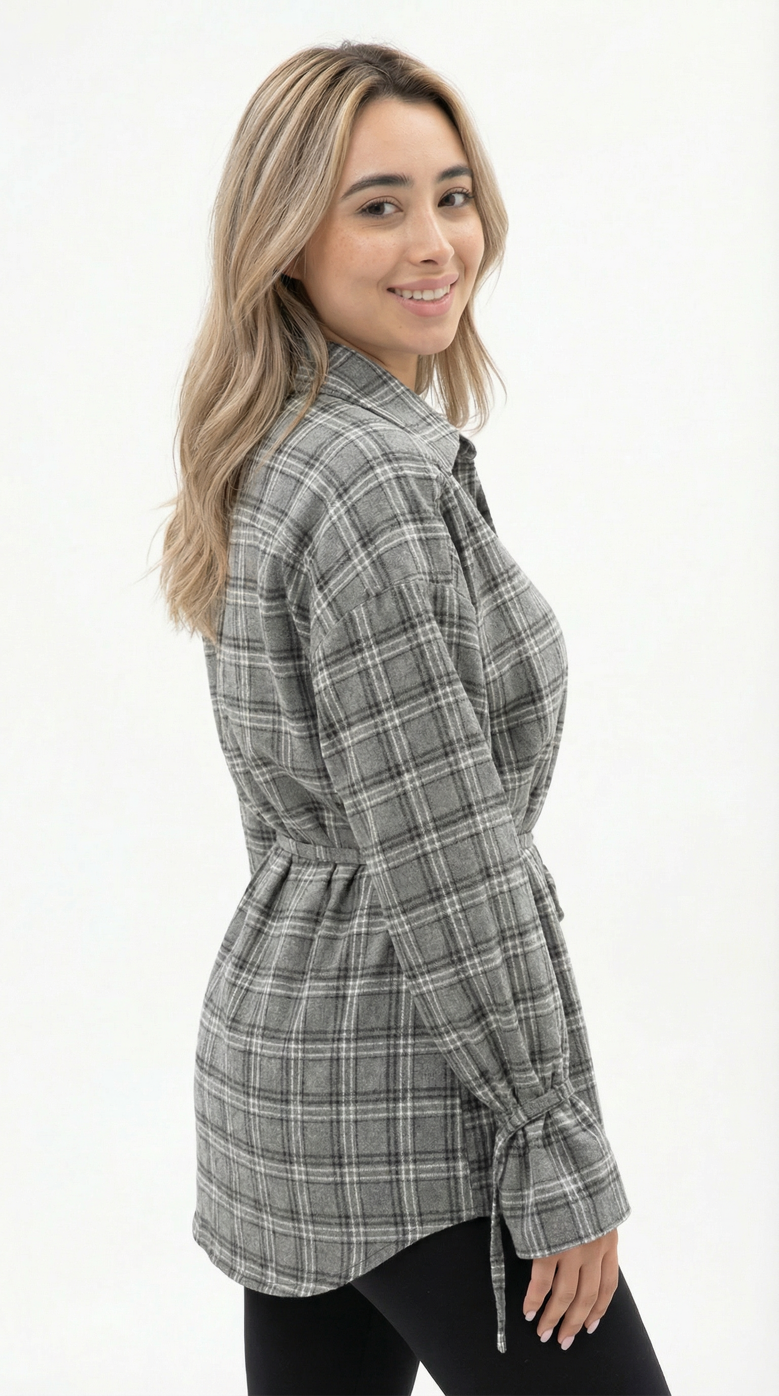 Woman wearing a gray plaid shirt on a white background