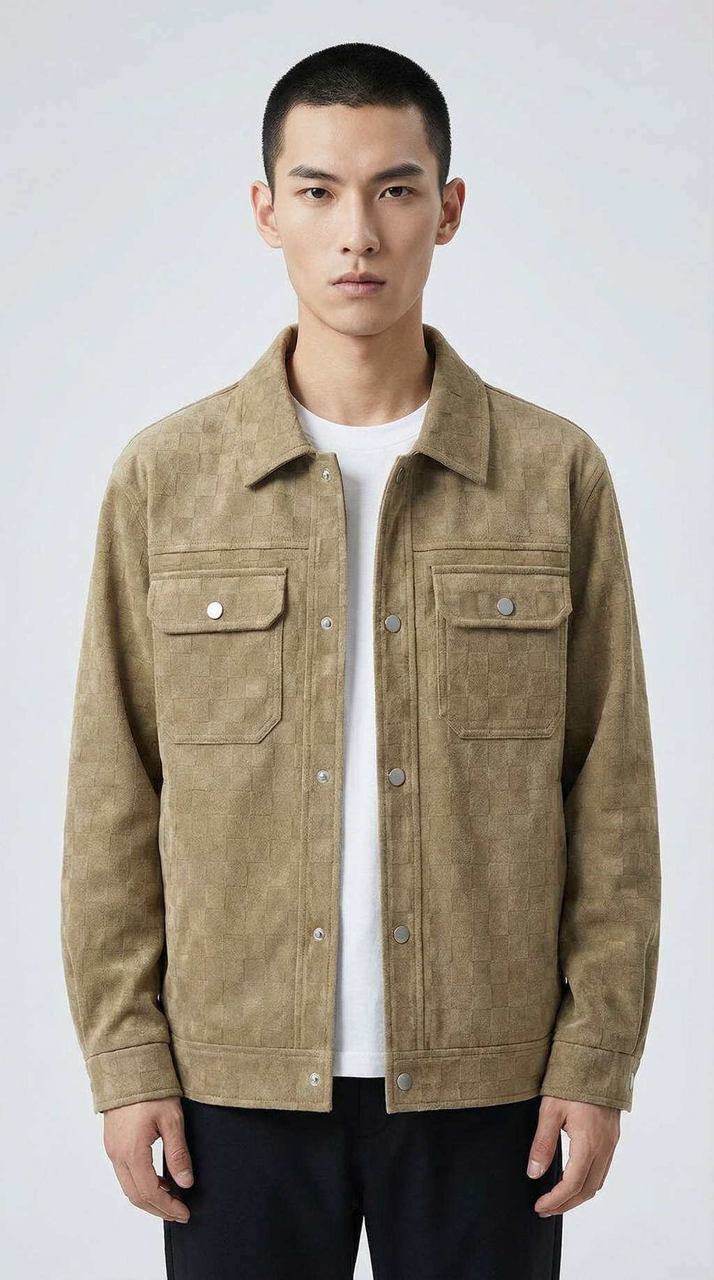 Man wearing a beige jacket over a white shirt from Meleche or Meléche (short as (Mé)) on a light gray background