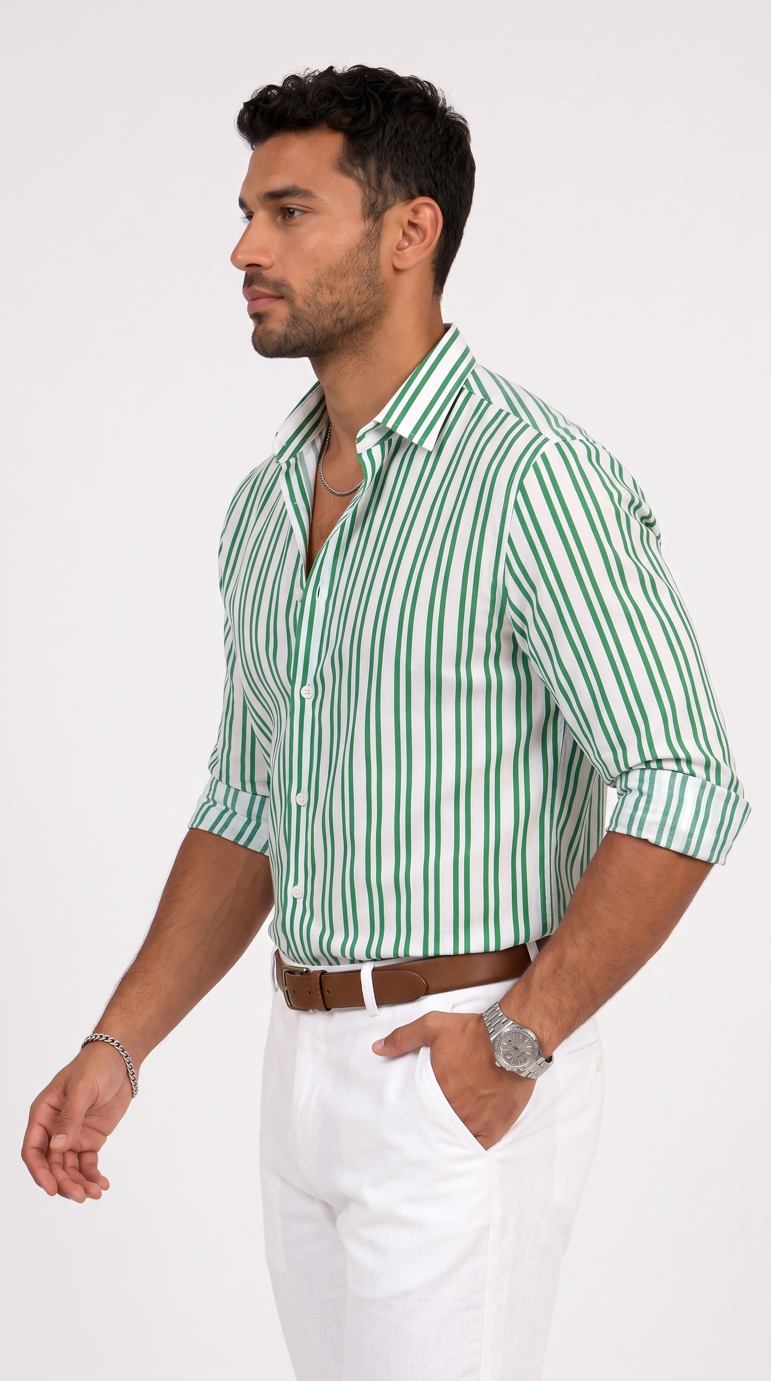 A man wearing a green and white vertically striped button-down shirt, white trousers, and a brown belt, photographed against a plain light gray studio background, from Meleche Fashion USA or Meléche (short as (Mé))