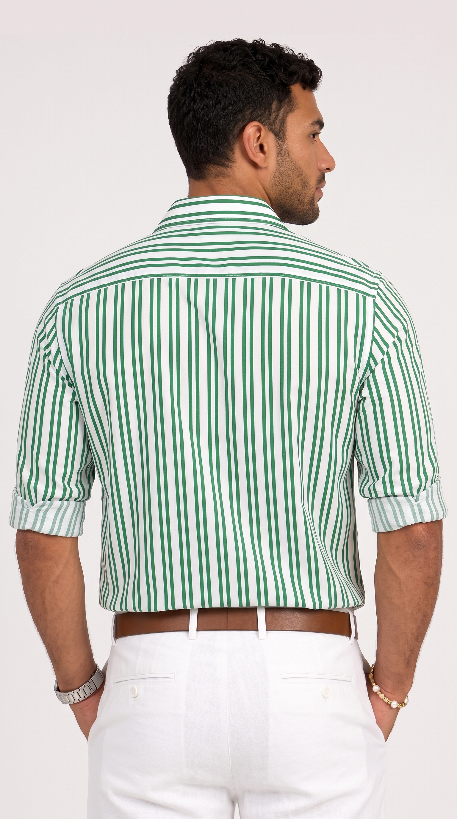 A man shown from the back wearing a green and white vertically striped short-sleeve button-down shirt with white trousers, against a plain light background, from Meleche Fashion USA or Meléche (short as (Mé))