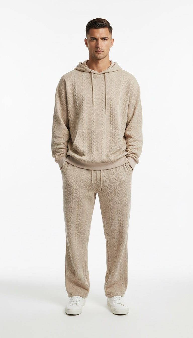 Man wearing a beige hoodie and pants set on a white background