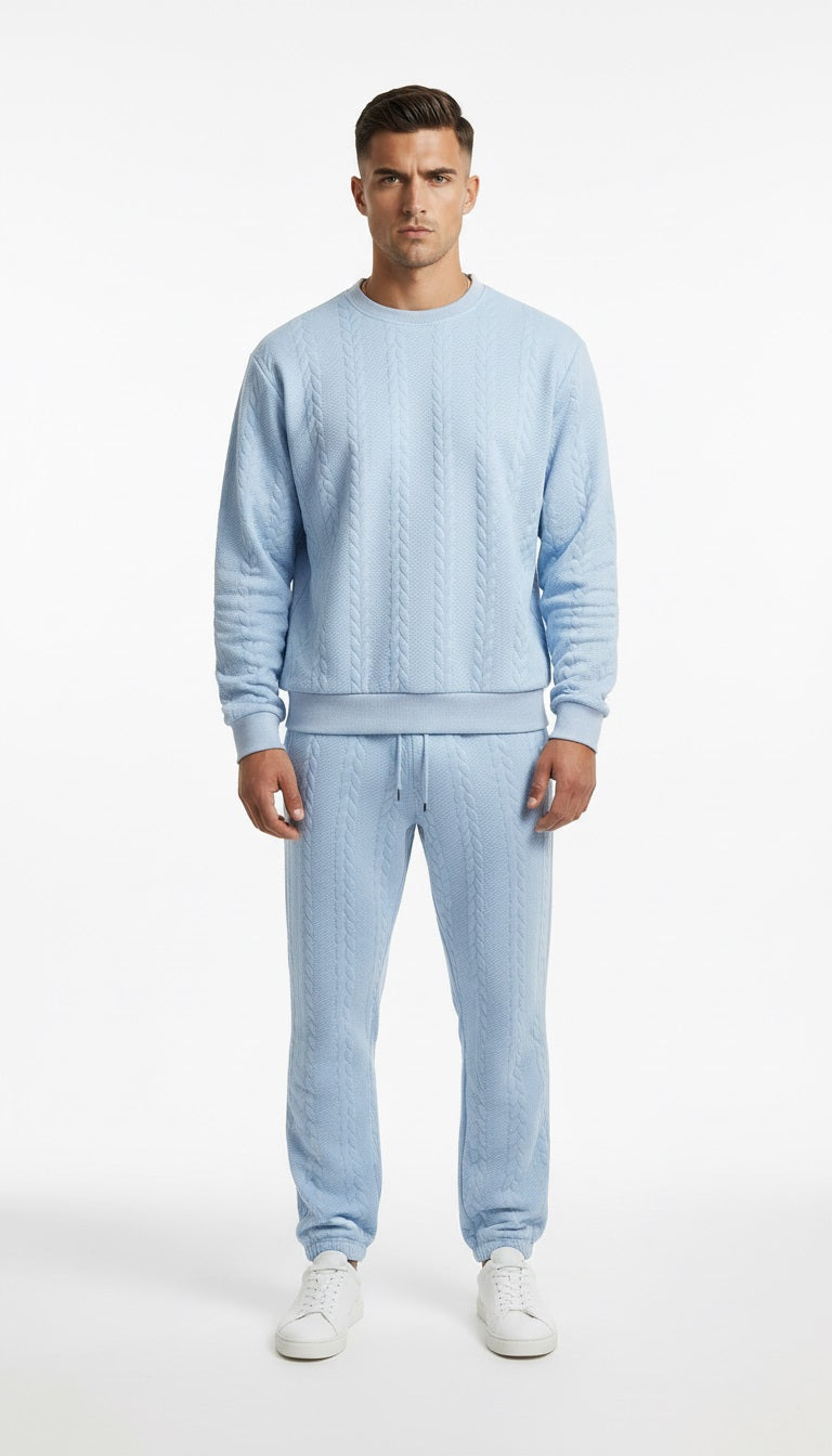 Man wearing a light blue sweater and pants set on a white background