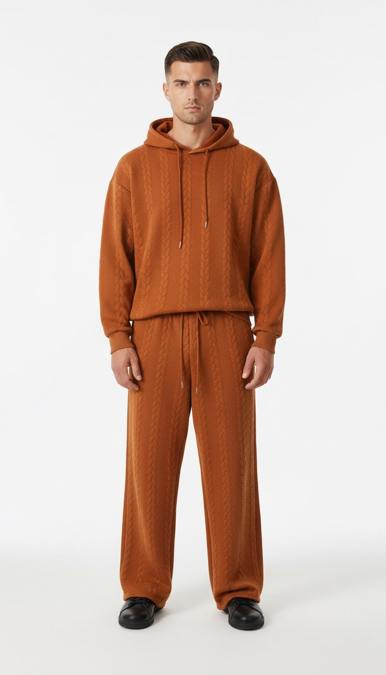 Man wearing a brown tracksuit on a white background