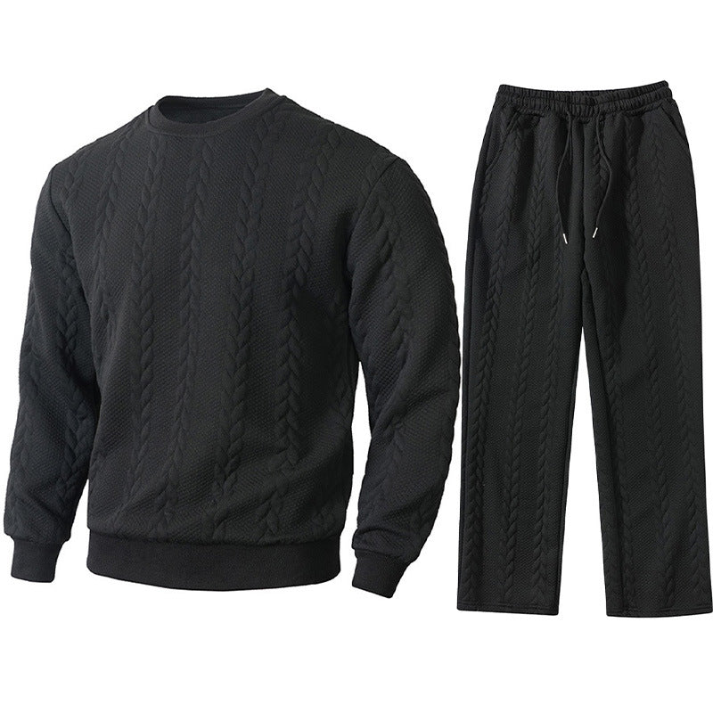 Black cable knit sweater and pants set on a white background