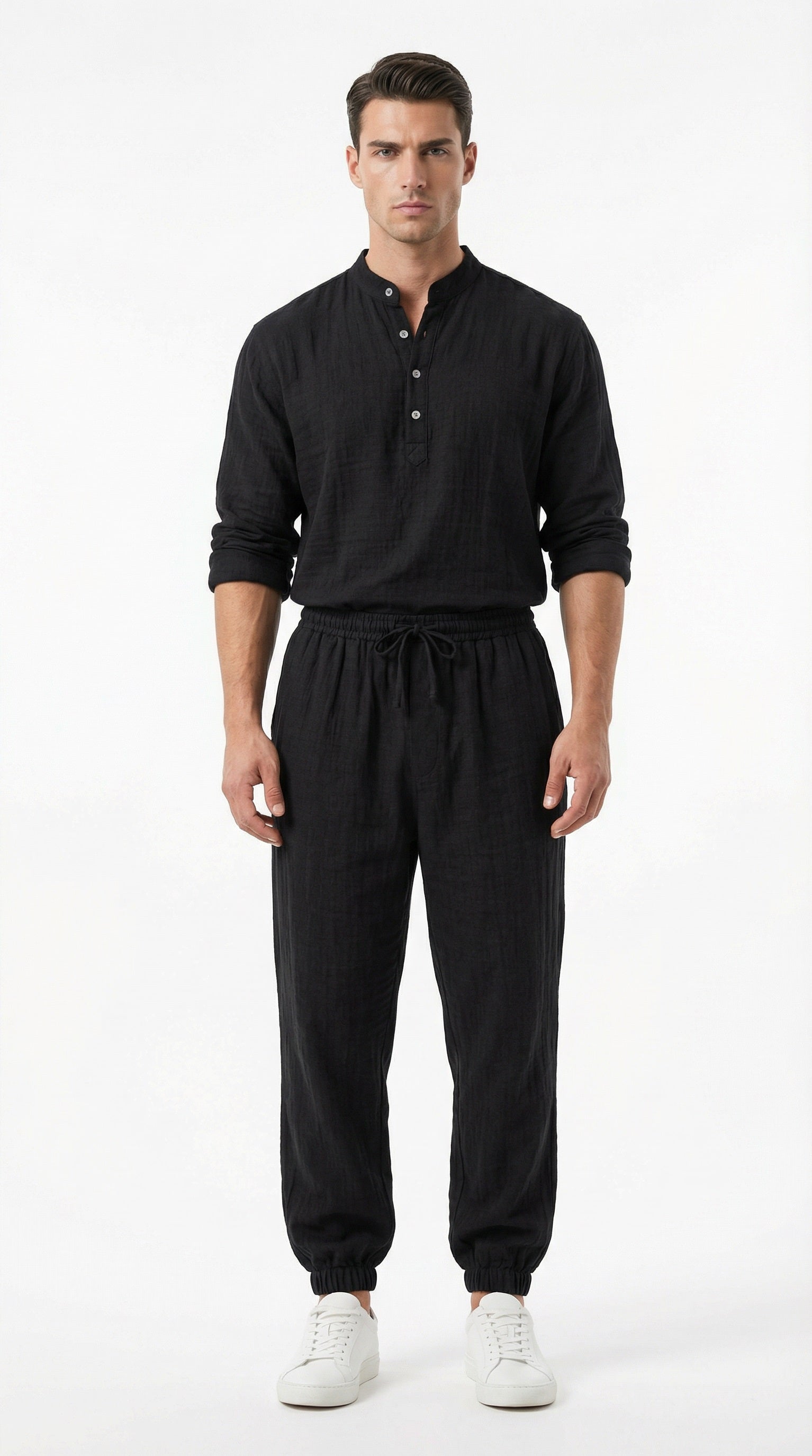 Man wearing a black outfit with a white background