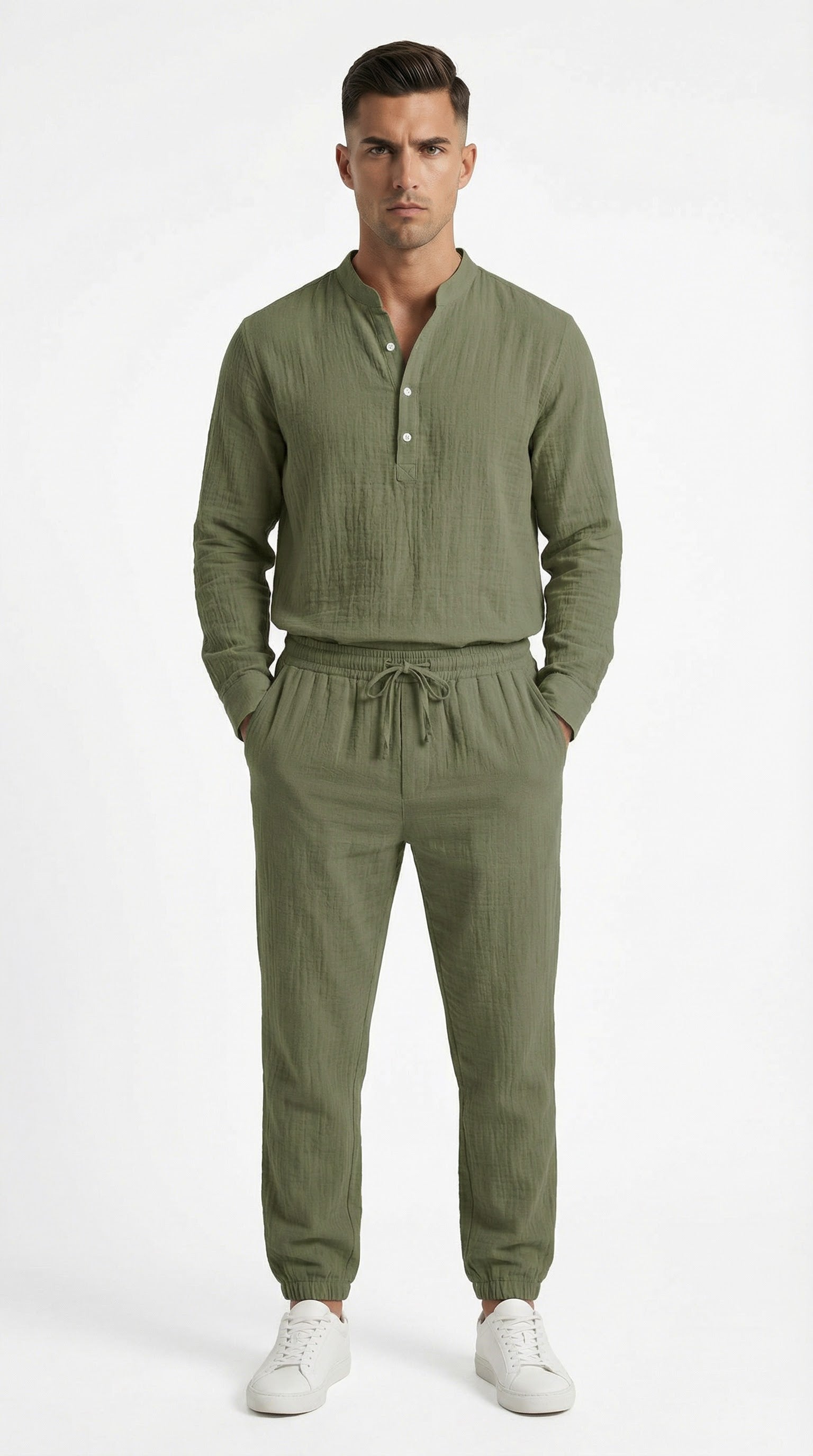 Man in olive green outfit standing on a balcony with ocean view and yachts.