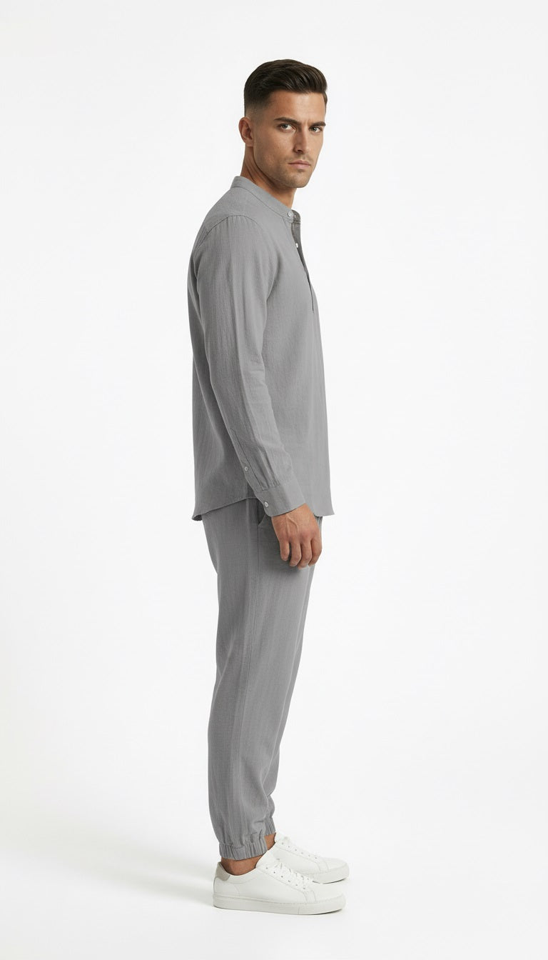 Man wearing a gray outfit on a white background