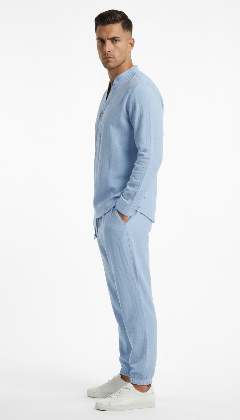 Man wearing a light blue pajama set on a white background