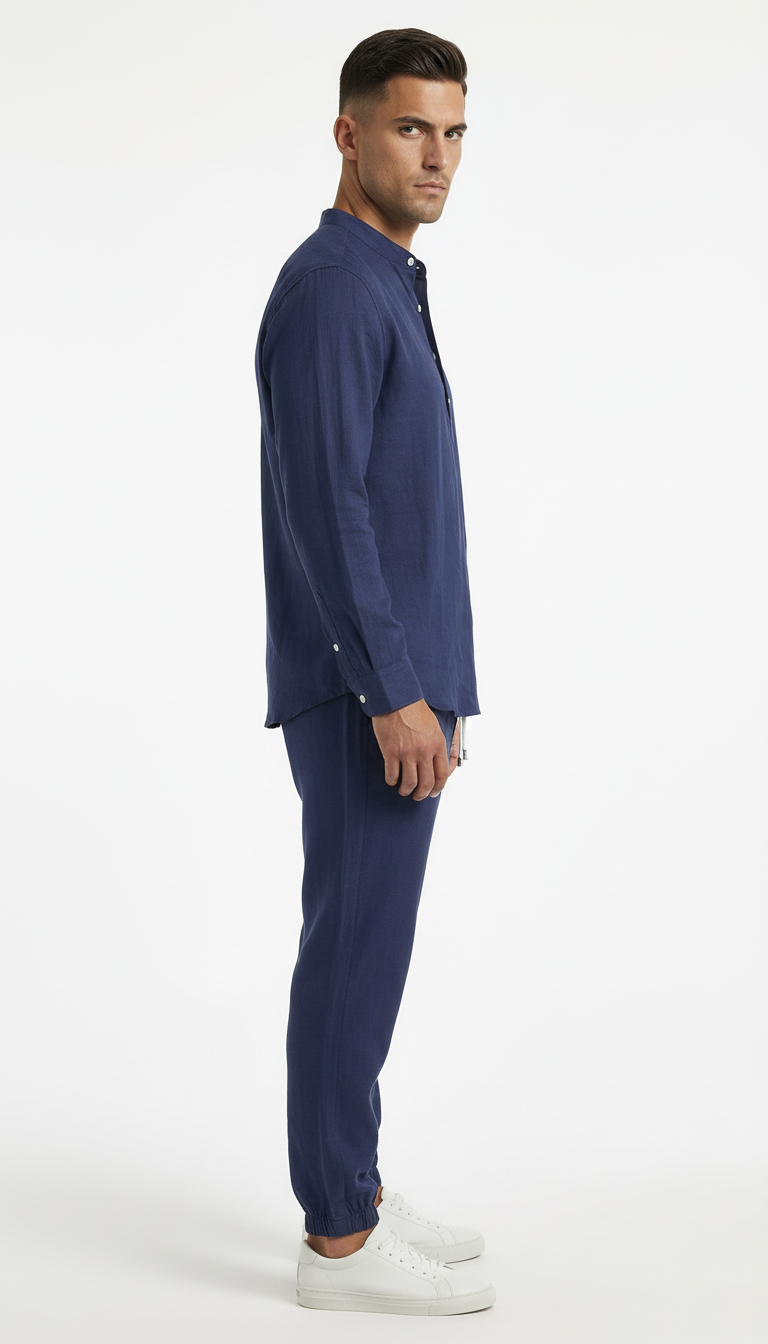 Man wearing a navy blue shirt and pants on a white background