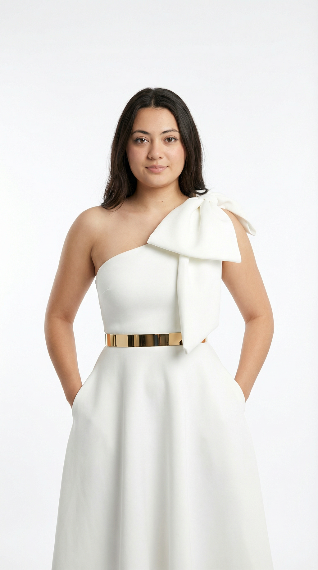 Woman wearing a white one-shoulder dress with a large bow on a white background