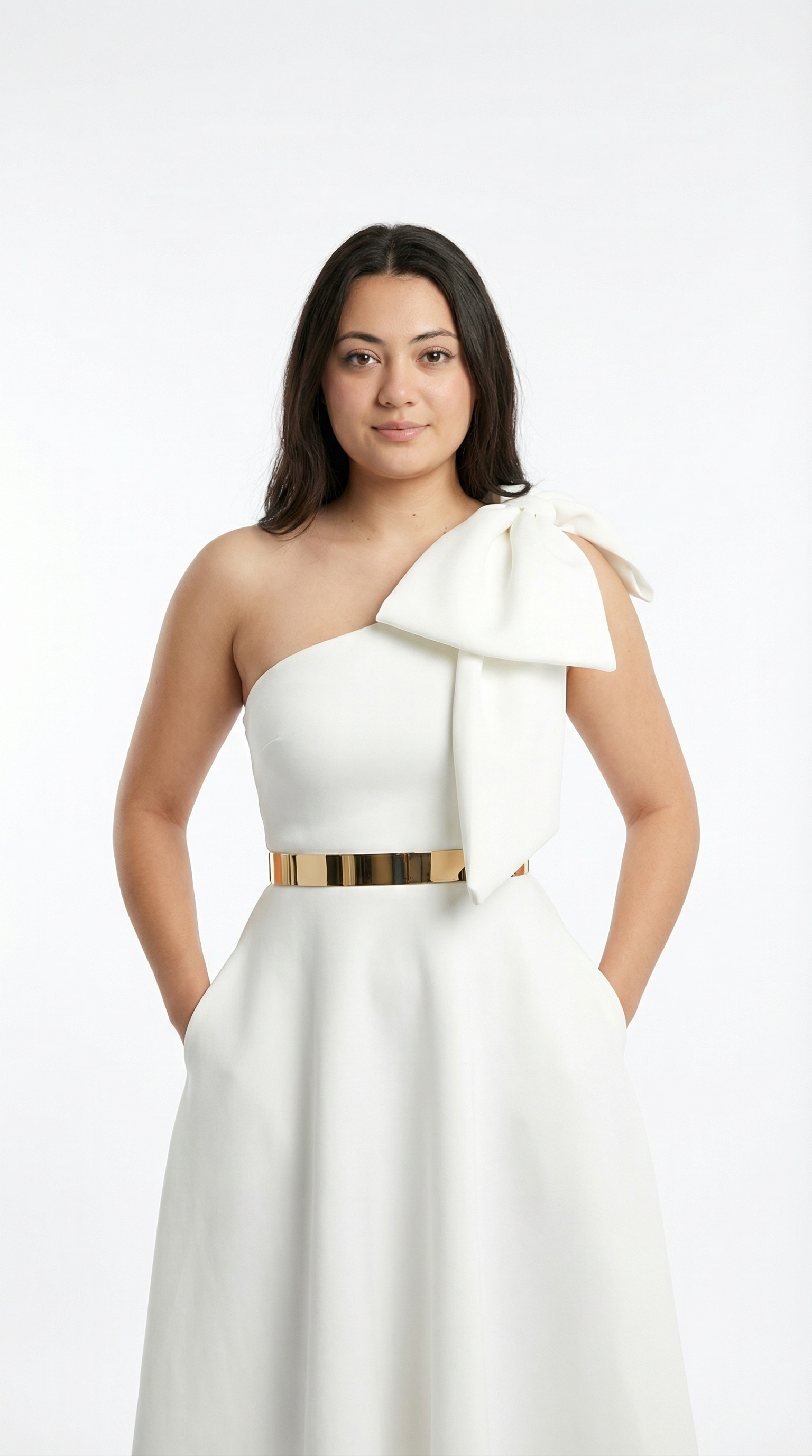 Woman wearing a white one-shoulder dress with a large bow on a white background