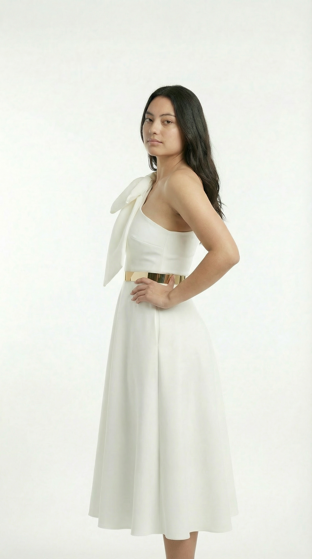 Woman wearing a white dress with a bow tie on a white background