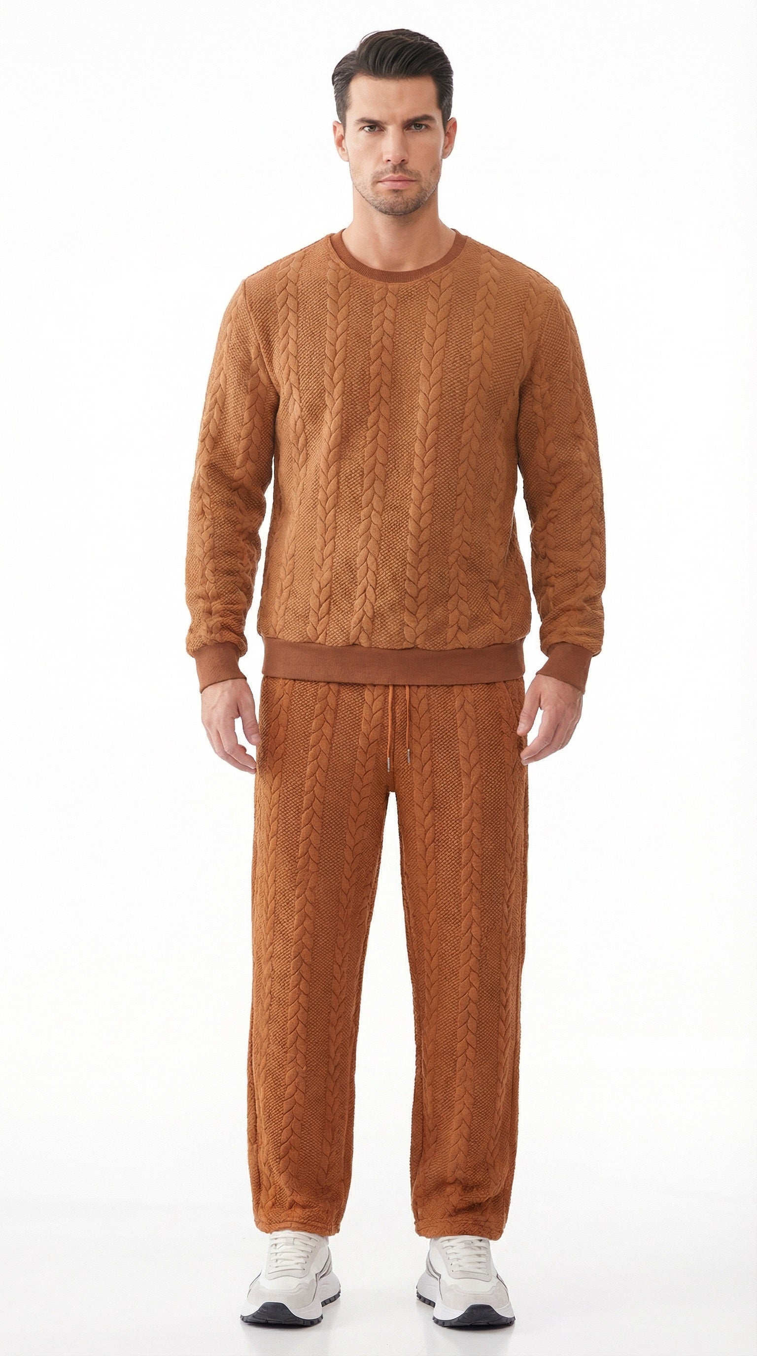 Man wearing a brown cable knit sweater and pants with additional color options displayed.