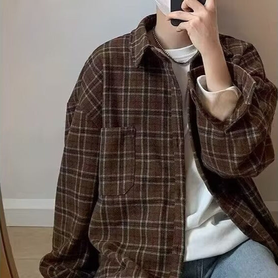 Person wearing a brown plaid shirt indoors