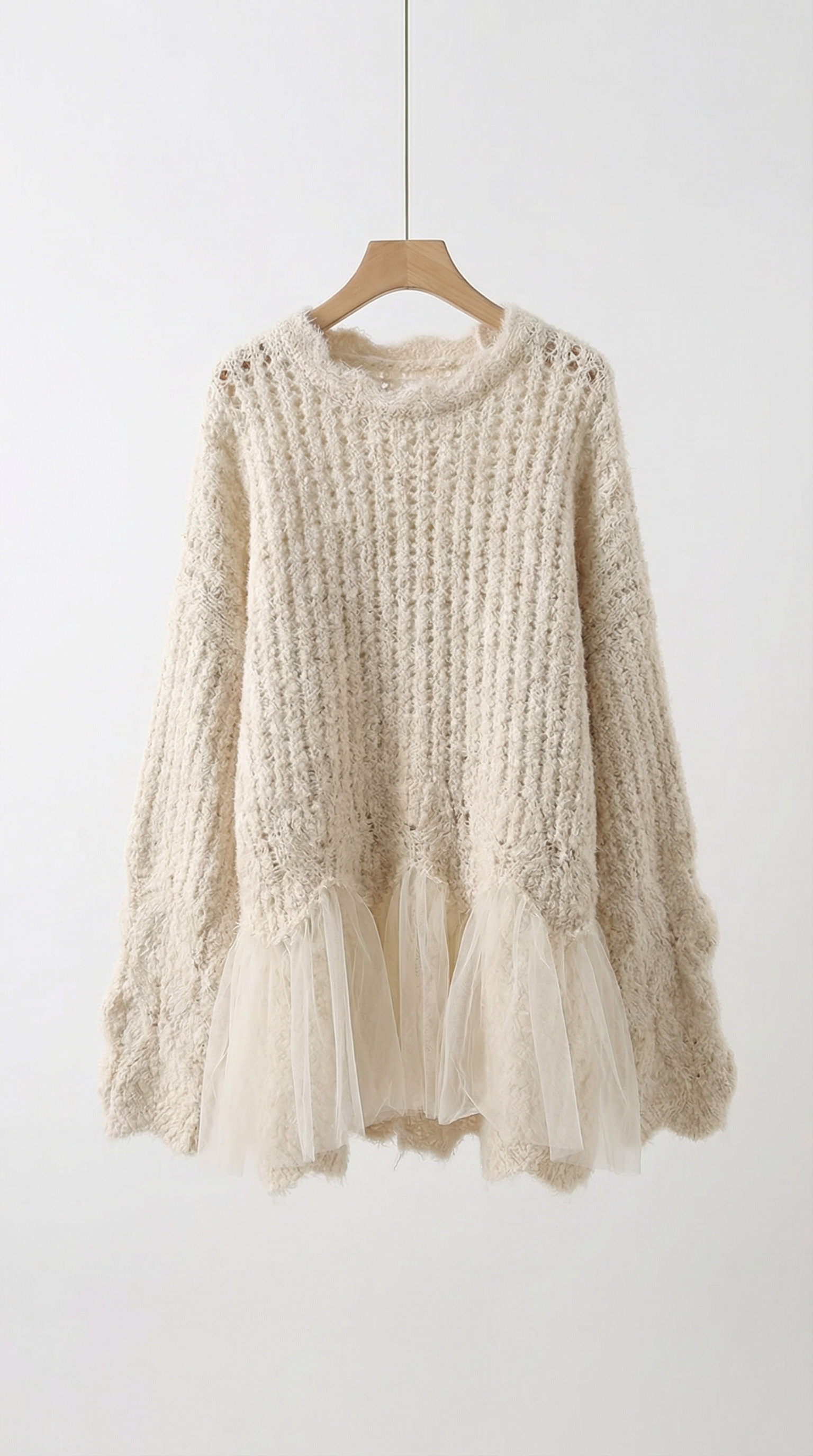 Beige knitted sweater with tulle details on a white background