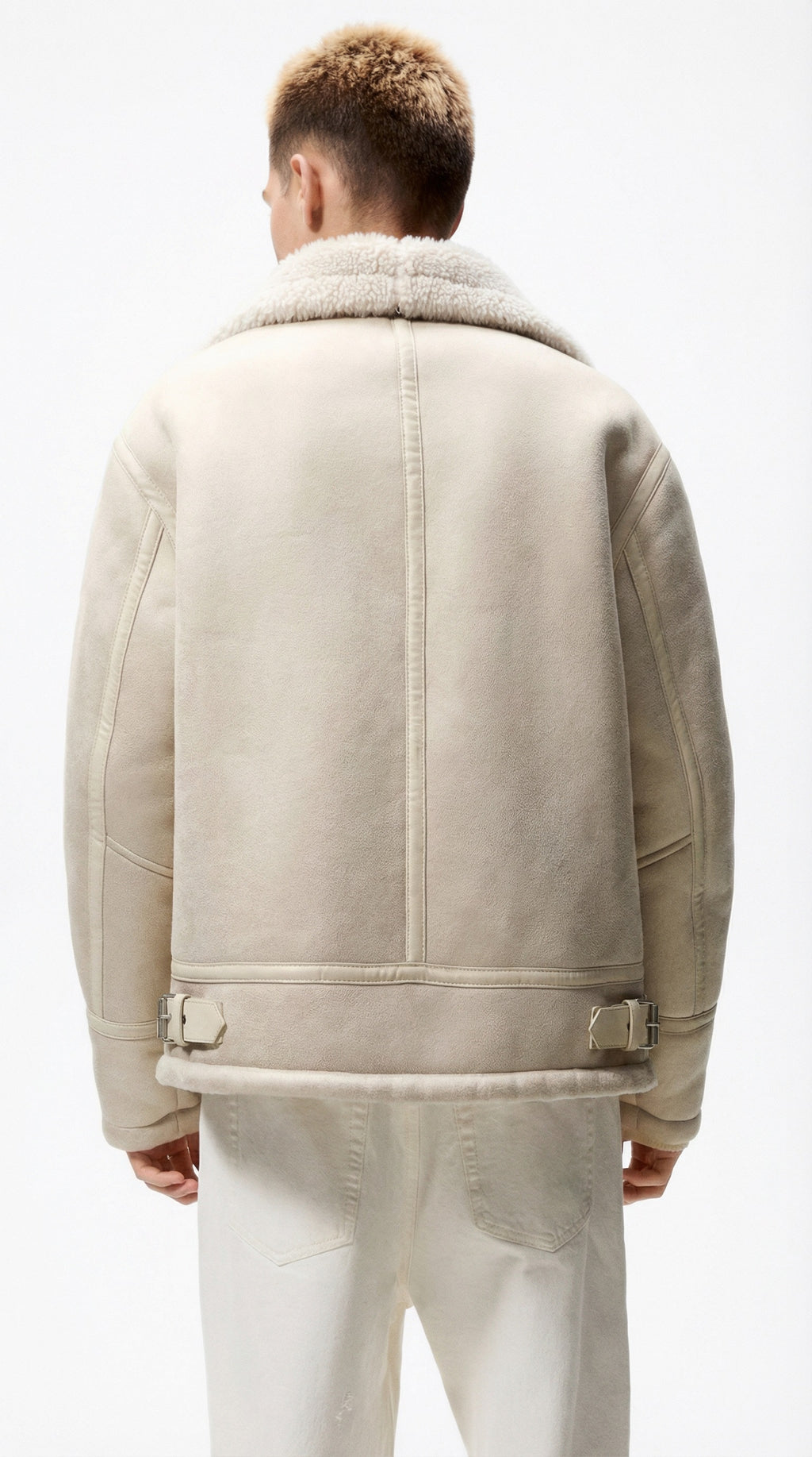 Person wearing a beige jacket from Meleche or Meléche (short as (Mé)) on a white background