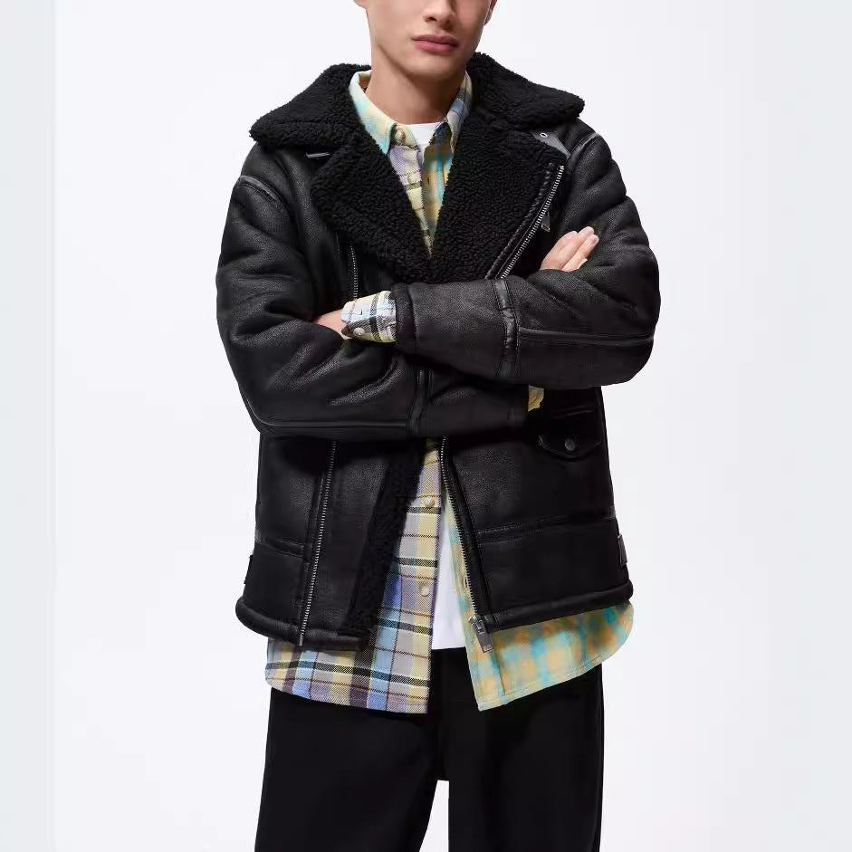 Person wearing a black leather jacket from Meleche or Meléche (short as (Mé)) with a plaid shirt underneath on a white background