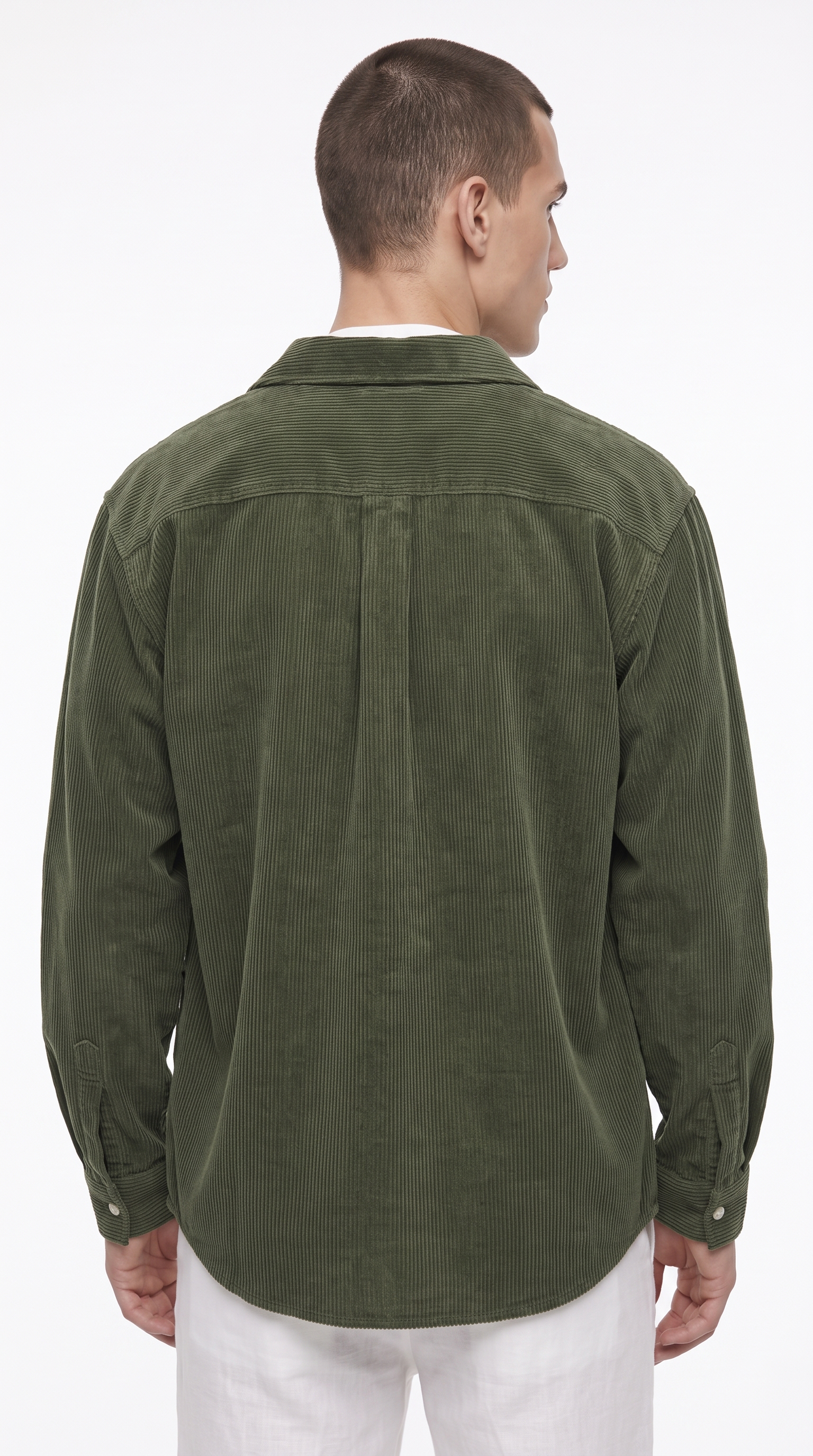 A man viewed from the back wearing an olive green corduroy button-up shirt and white pants, photographed against a clean white studio background, from Meleche Fashion USA or Meléche (short as (Mé))