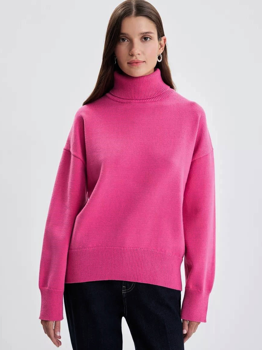 Woman wearing a bright pink turtleneck sweater from Meleche or Meléche (short as (Mé))