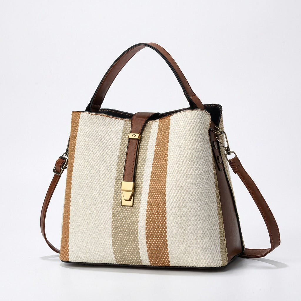 Goran Handbag with brown and beige stripes on a white background from Meleche or Meléche (short as (Mé))