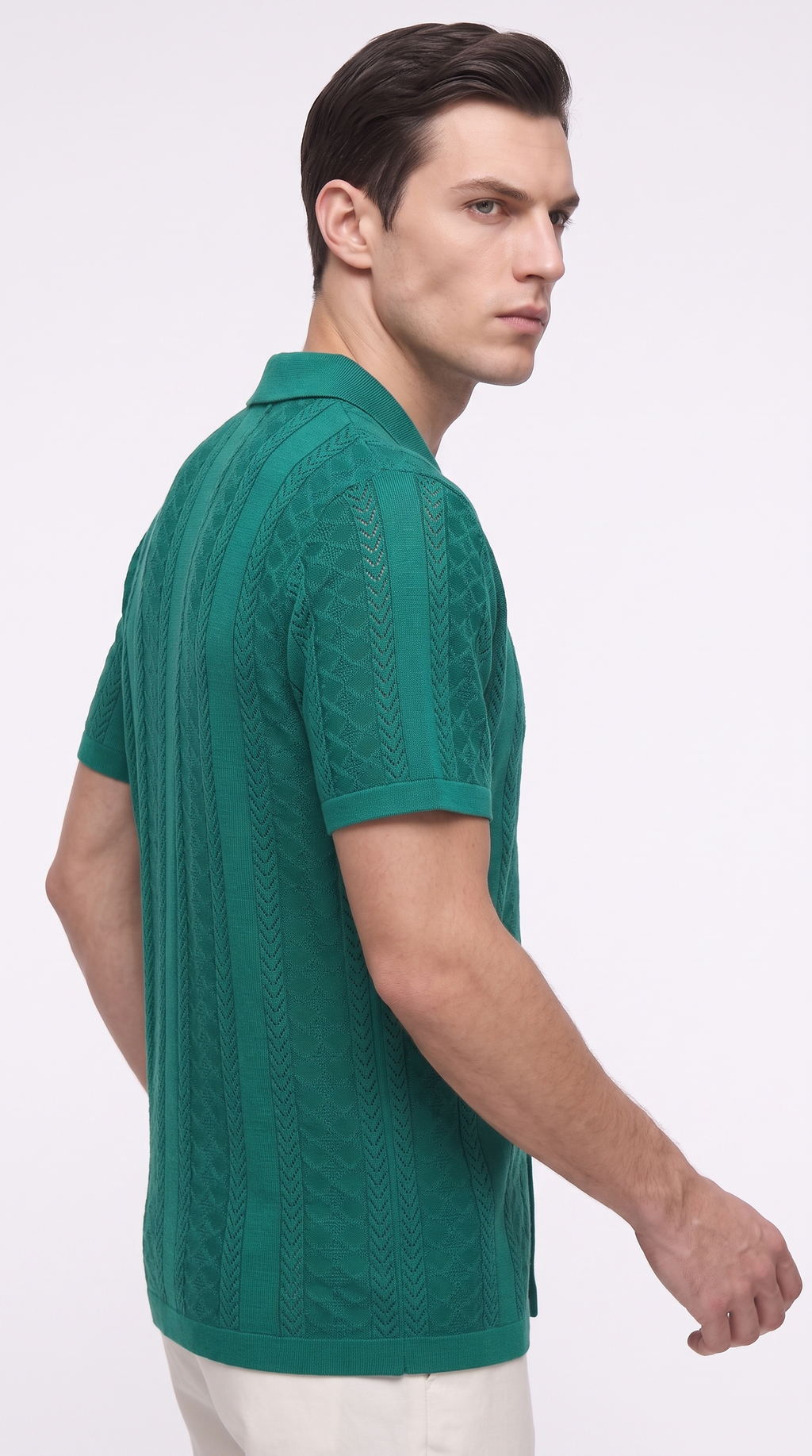A man wearing a green short-sleeve knit polo shirt with vertical textured patterns, shown from a side-back angle against a plain white studio background, from Meleche Fashion USA or Meléche (short as (Mé))