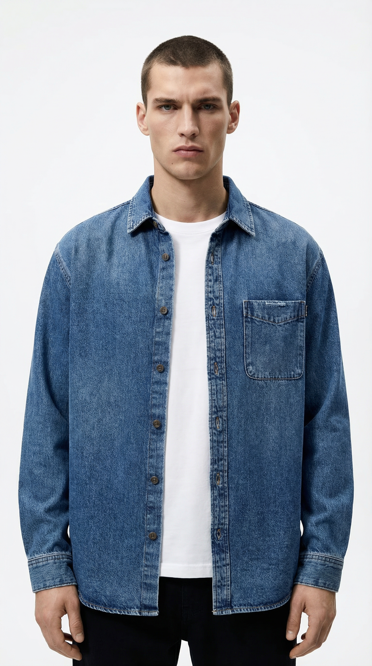 Man wearing a blue denim jacket over a white shirt from Meleche or Meléche (short as (Mé))