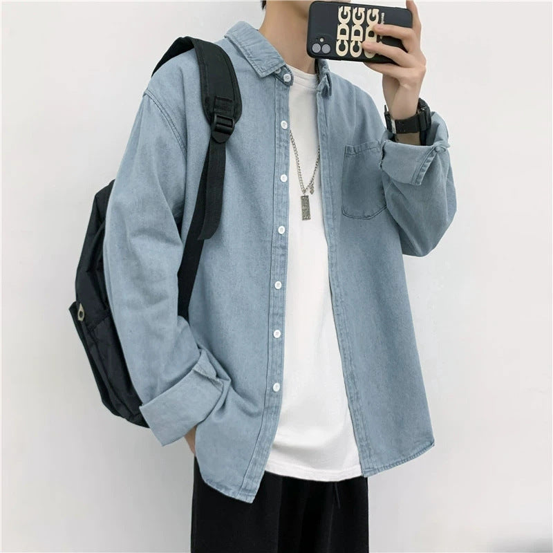 Person wearing a light blue denim shirt with a black backpack on a white background