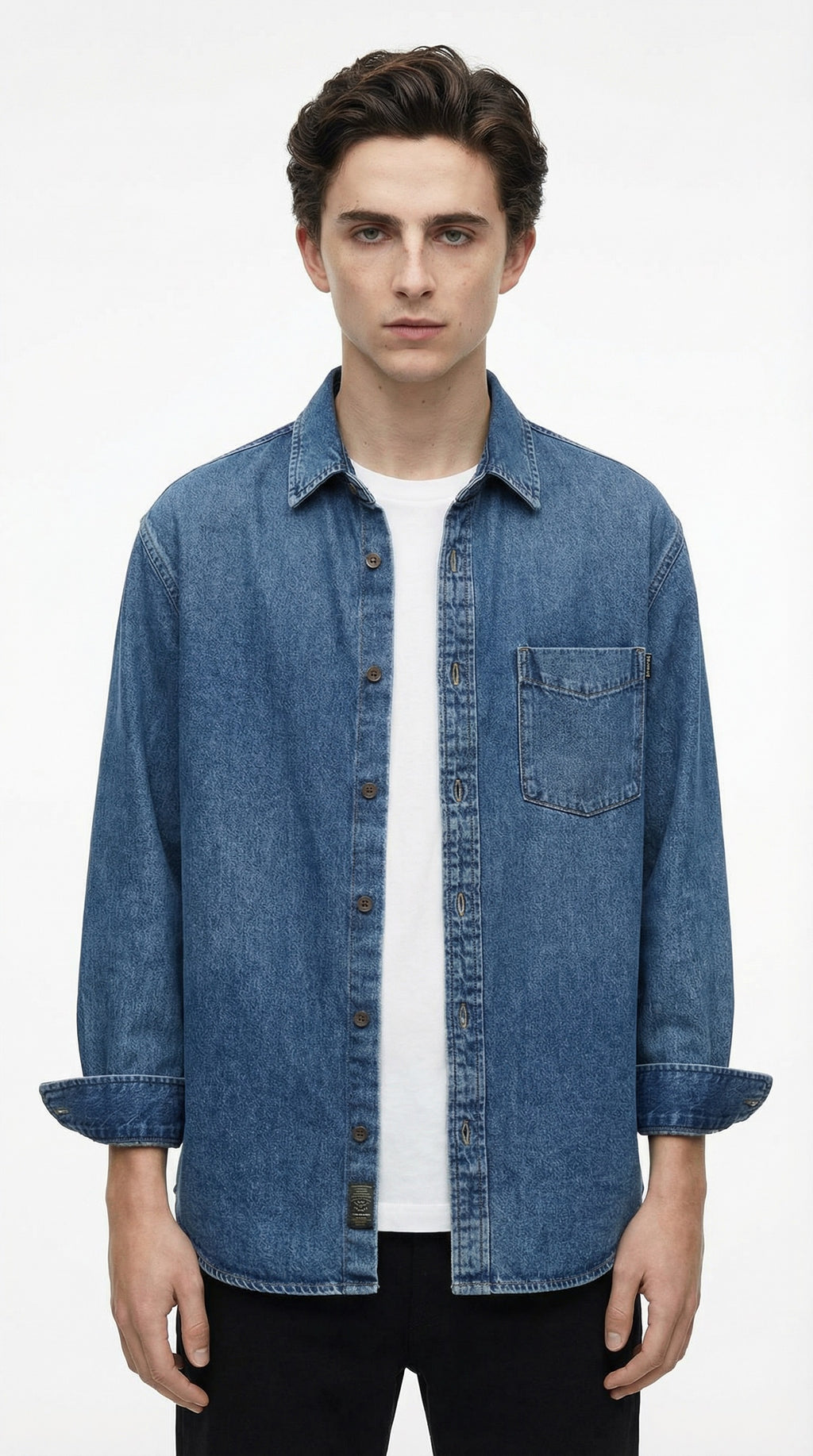 Blue denim shirt on a hanger against a gray background