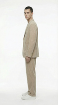 Man wearing a beige suit standing from Meleche or Meléche (short as (Mé))