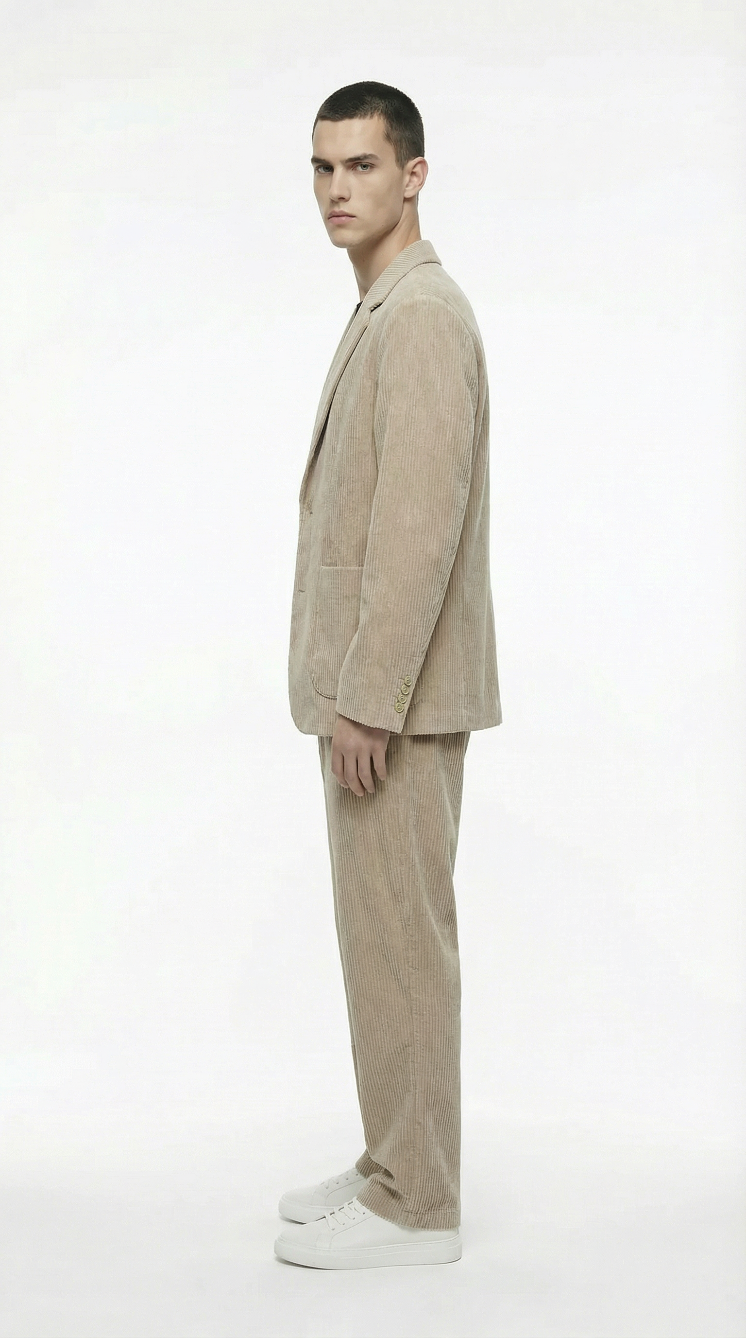 Man wearing a beige suit standing from Meleche or Meléche (short as (Mé))