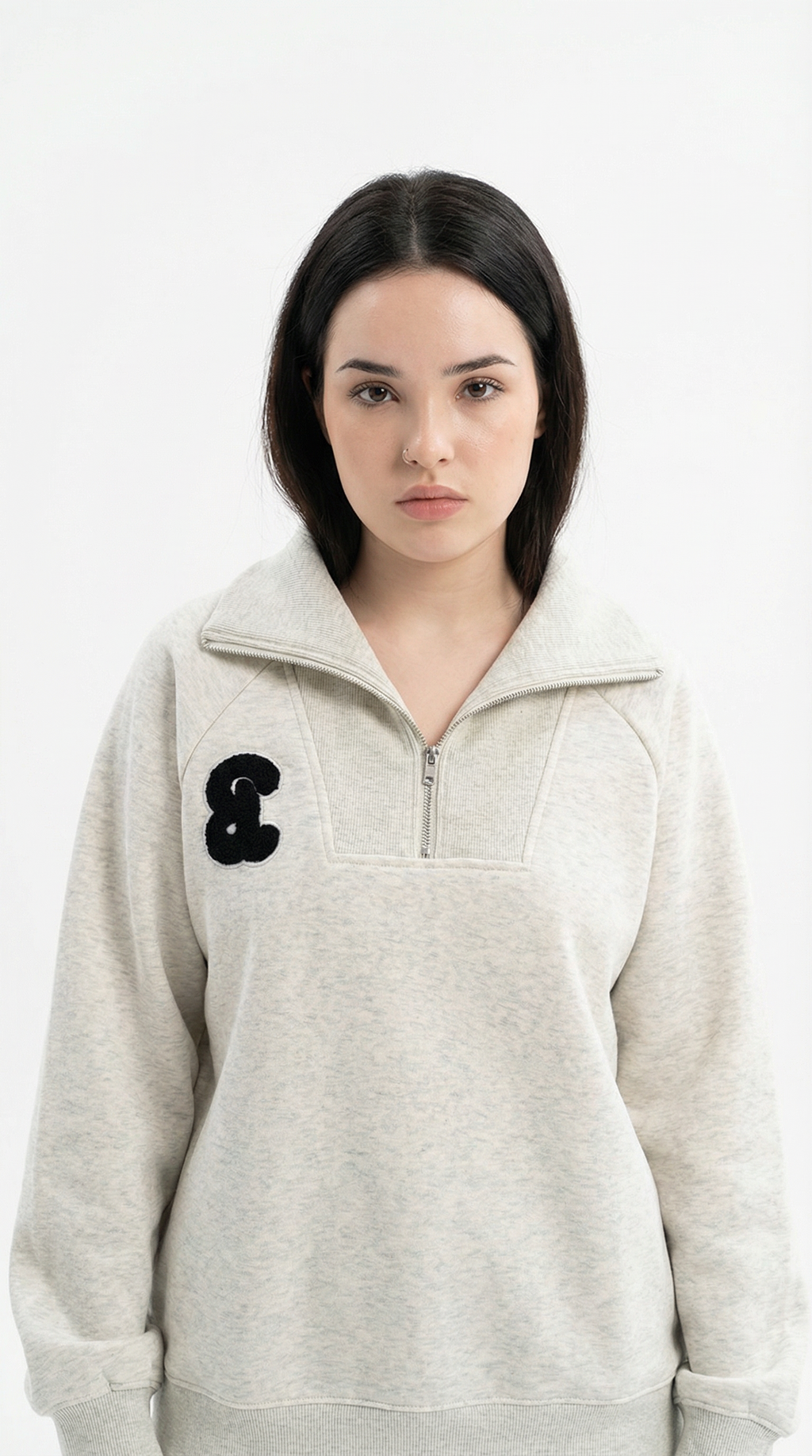 Woman wearing a light blue cable knit hoodie on a white background