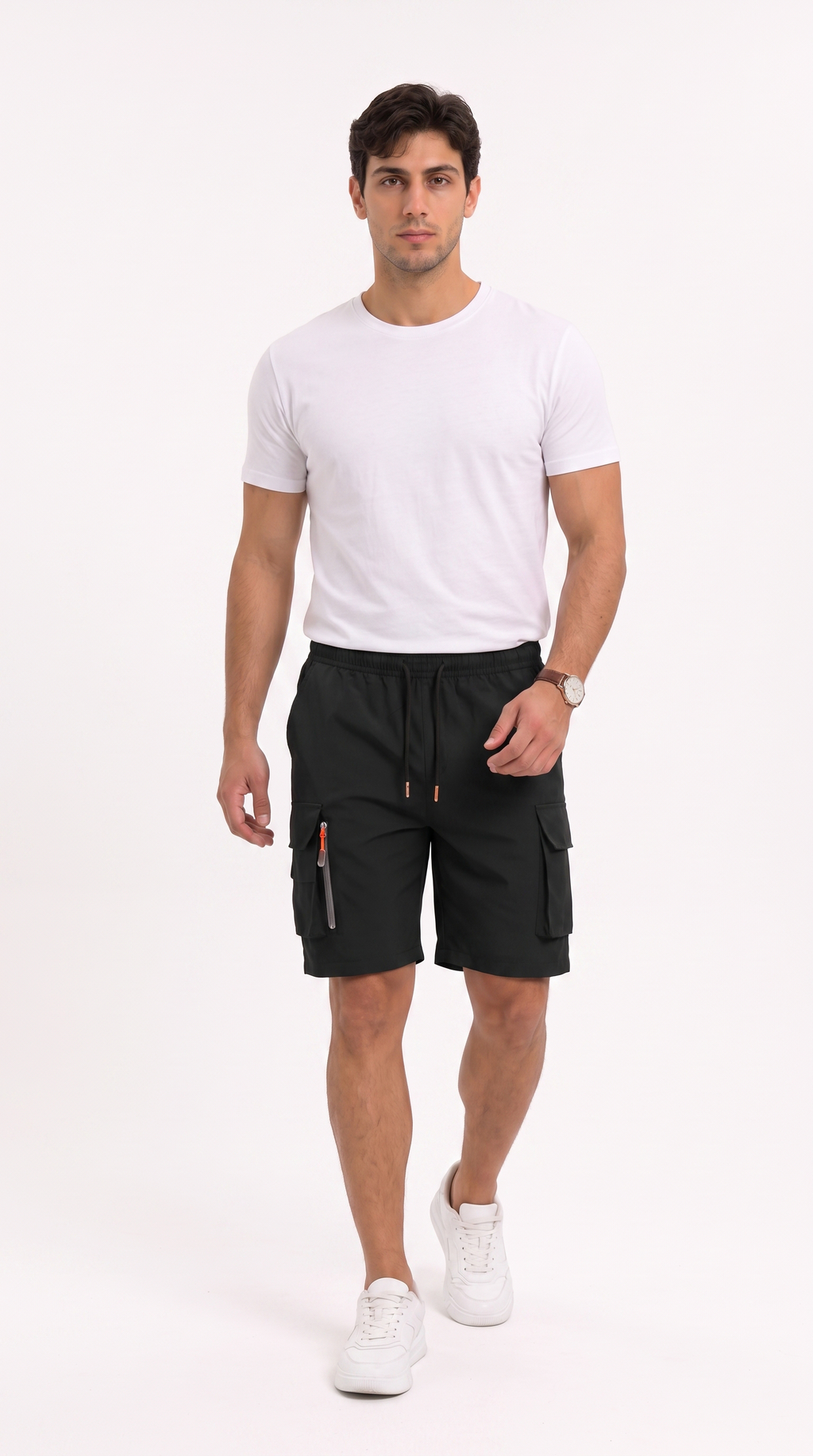A man modeling black cargo shorts with white sneakers and a white t-shirt, standing against a plain white studio background, from Meleche Fashion USA or Meléche (short as (Mé))