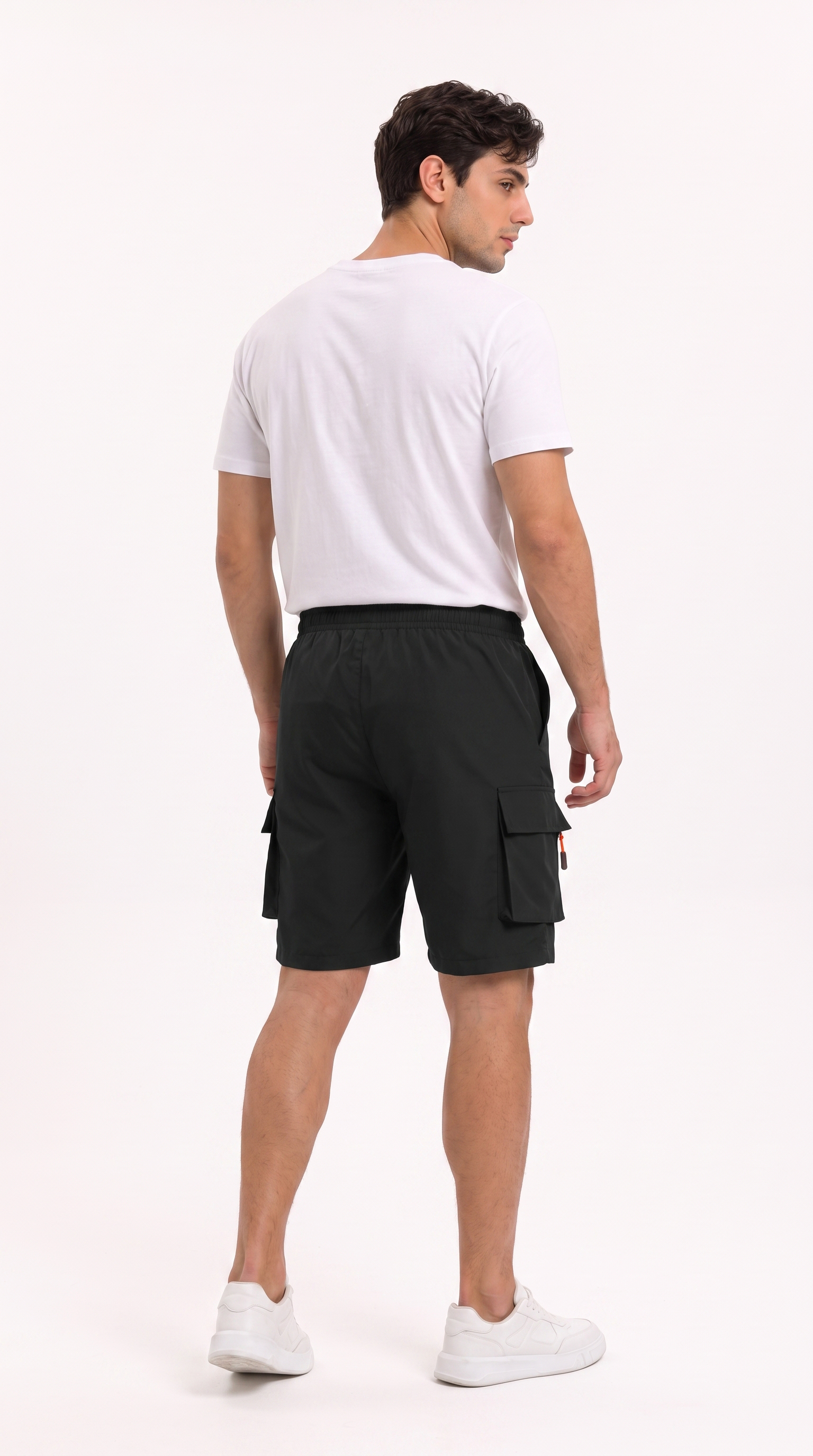 A man shown from the back wearing black cargo shorts, a white t-shirt, and white sneakers against a plain white studio background, from Meleche Fashion USA or Meléche (short as (Mé))