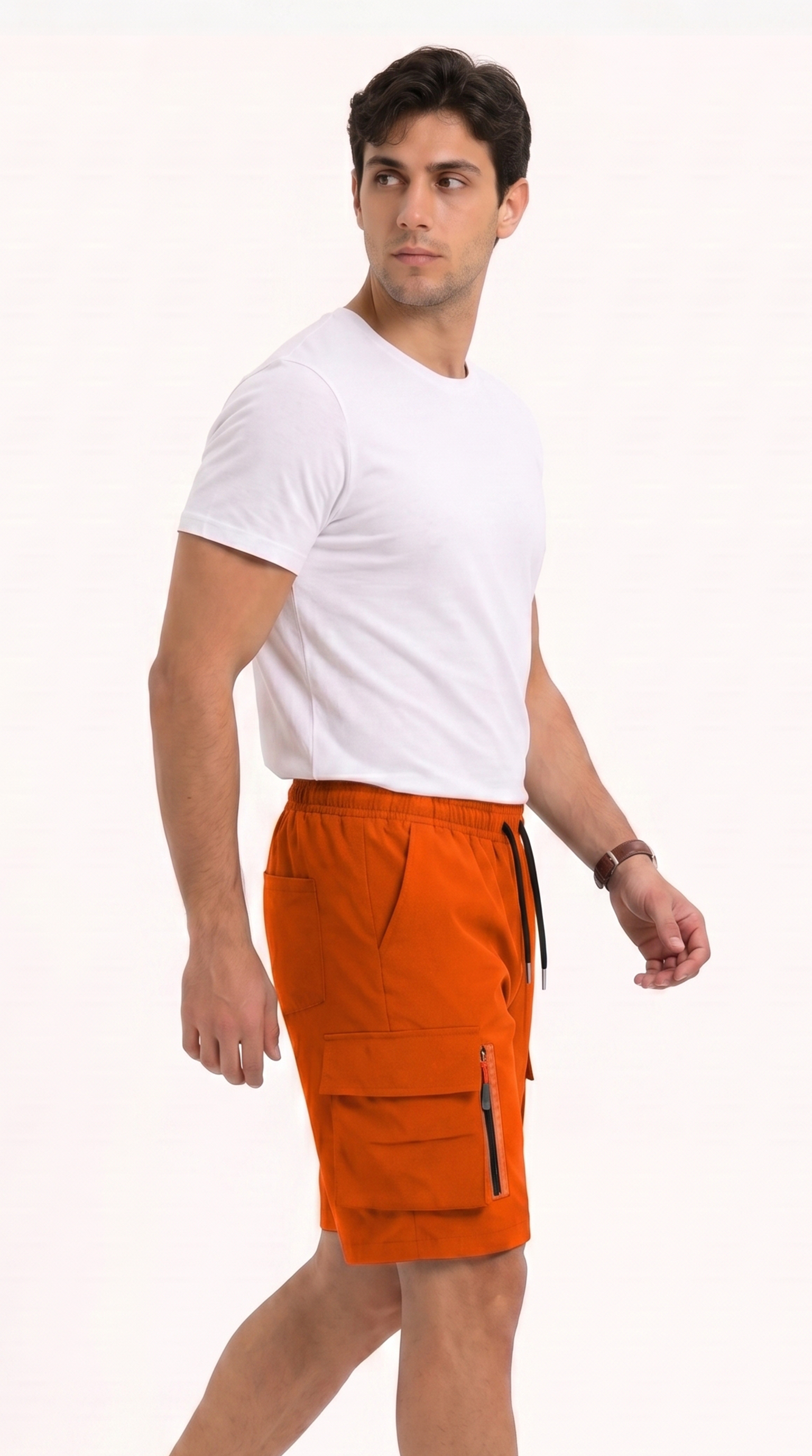 A man wearing bright orange cargo shorts with black drawstrings and a white t-shirt, standing against a plain white studio background, from Meleche Fashion USA or Meléche (short as (Mé))