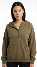 Woman wearing a brown pullover with a hood from Meleche or Meléche (short as (Mé))