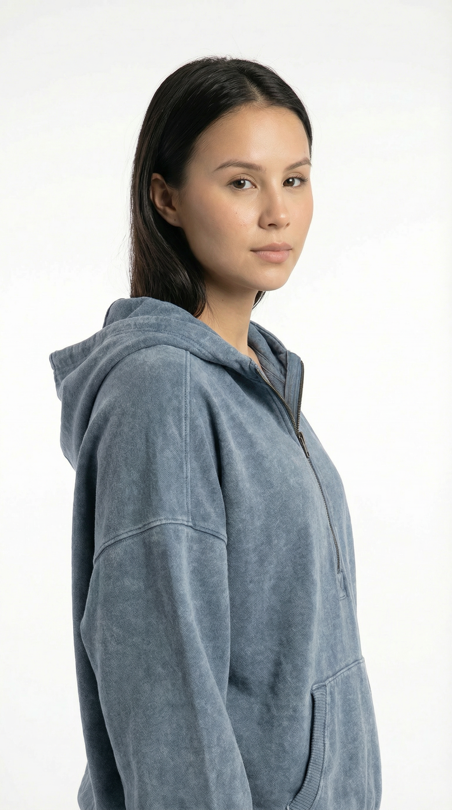 Woman wearing a gray hoodie against a white background