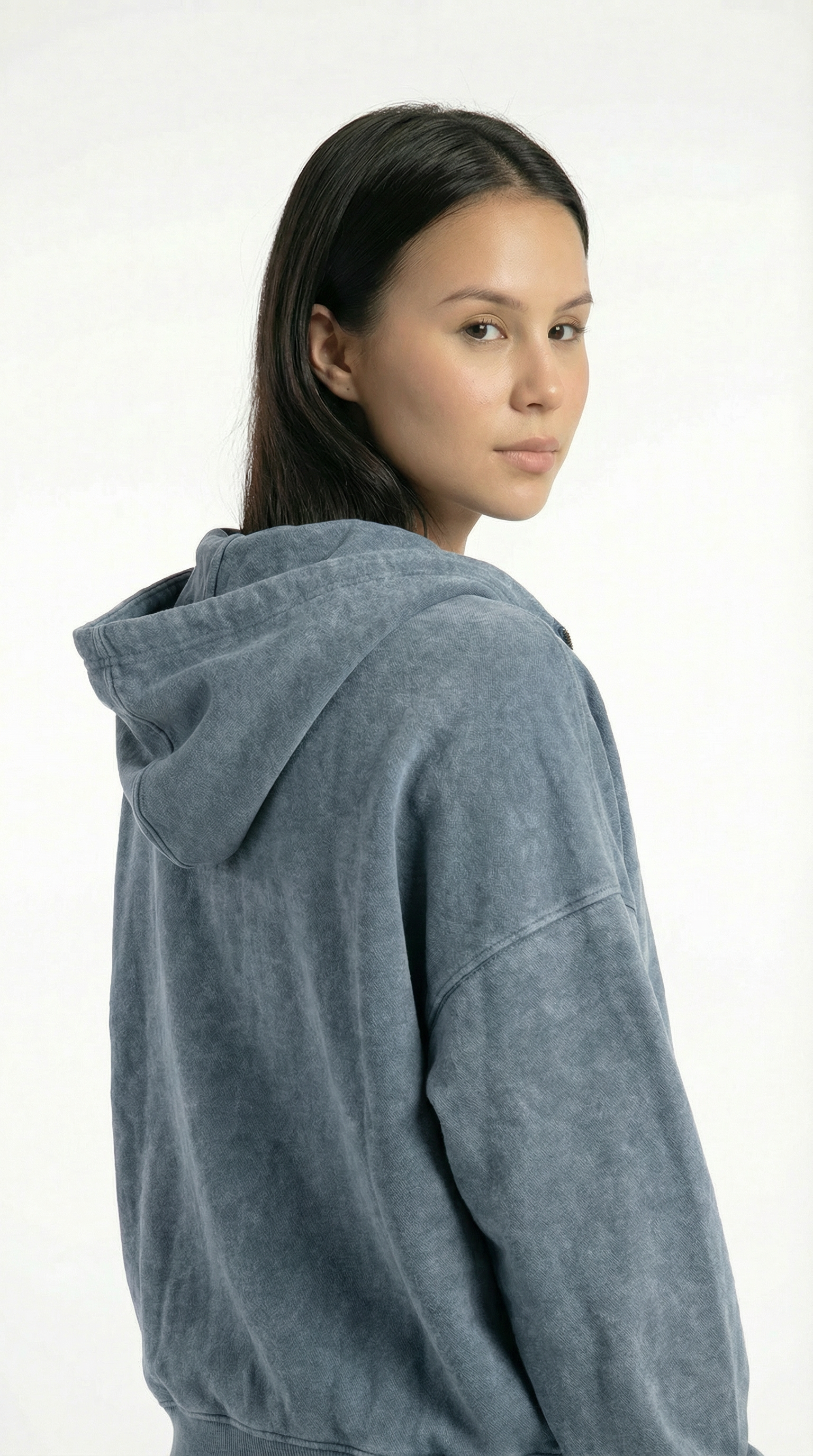 Person wearing a gray hoodie on a white background