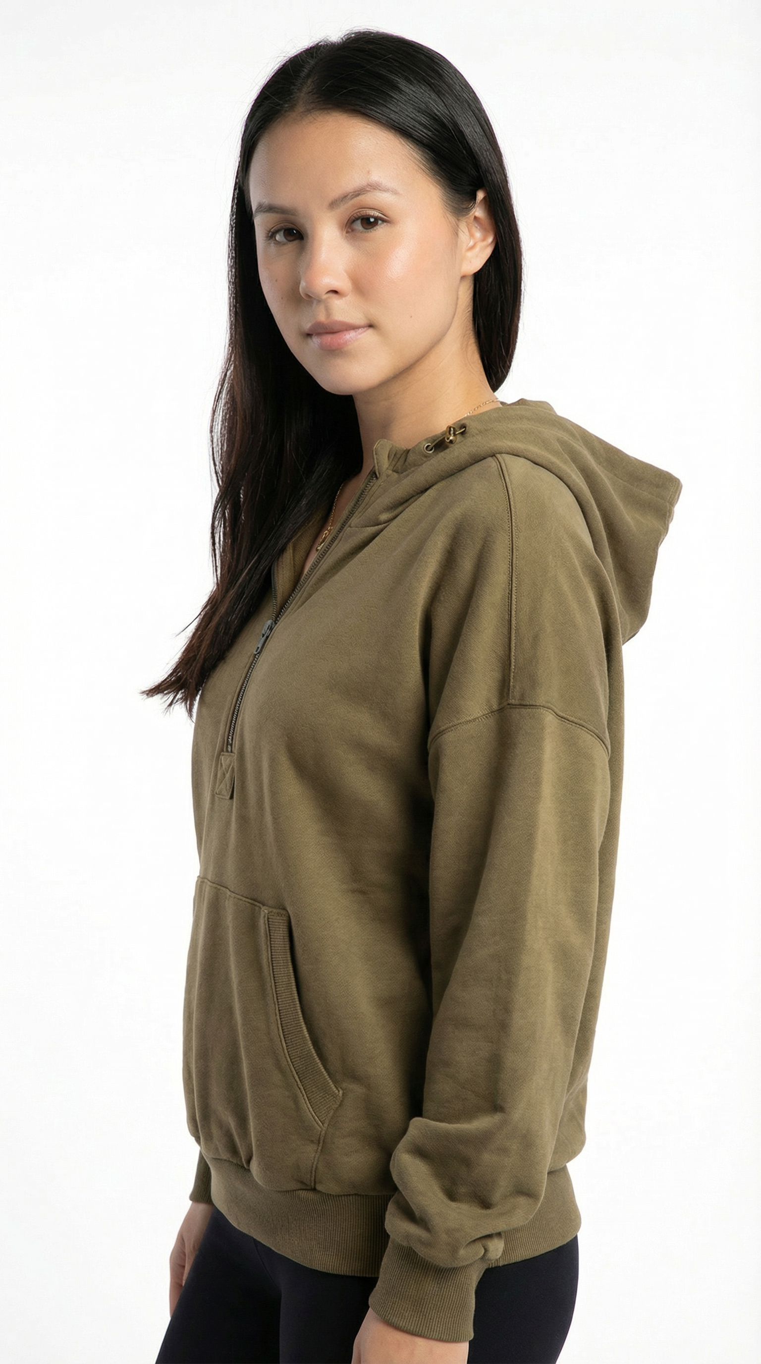 Lady wearing a green patterned shirt against a white background