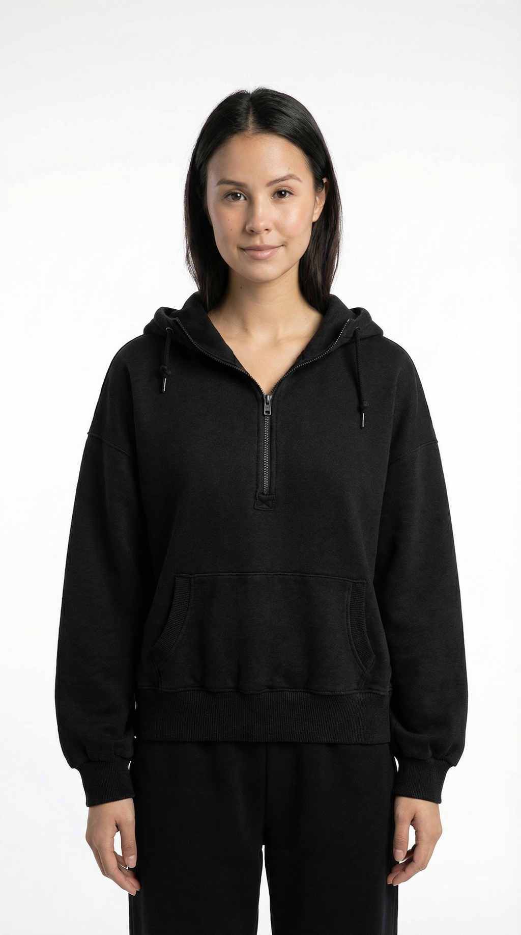 Person wearing a black hoodie with a zipper on a white background