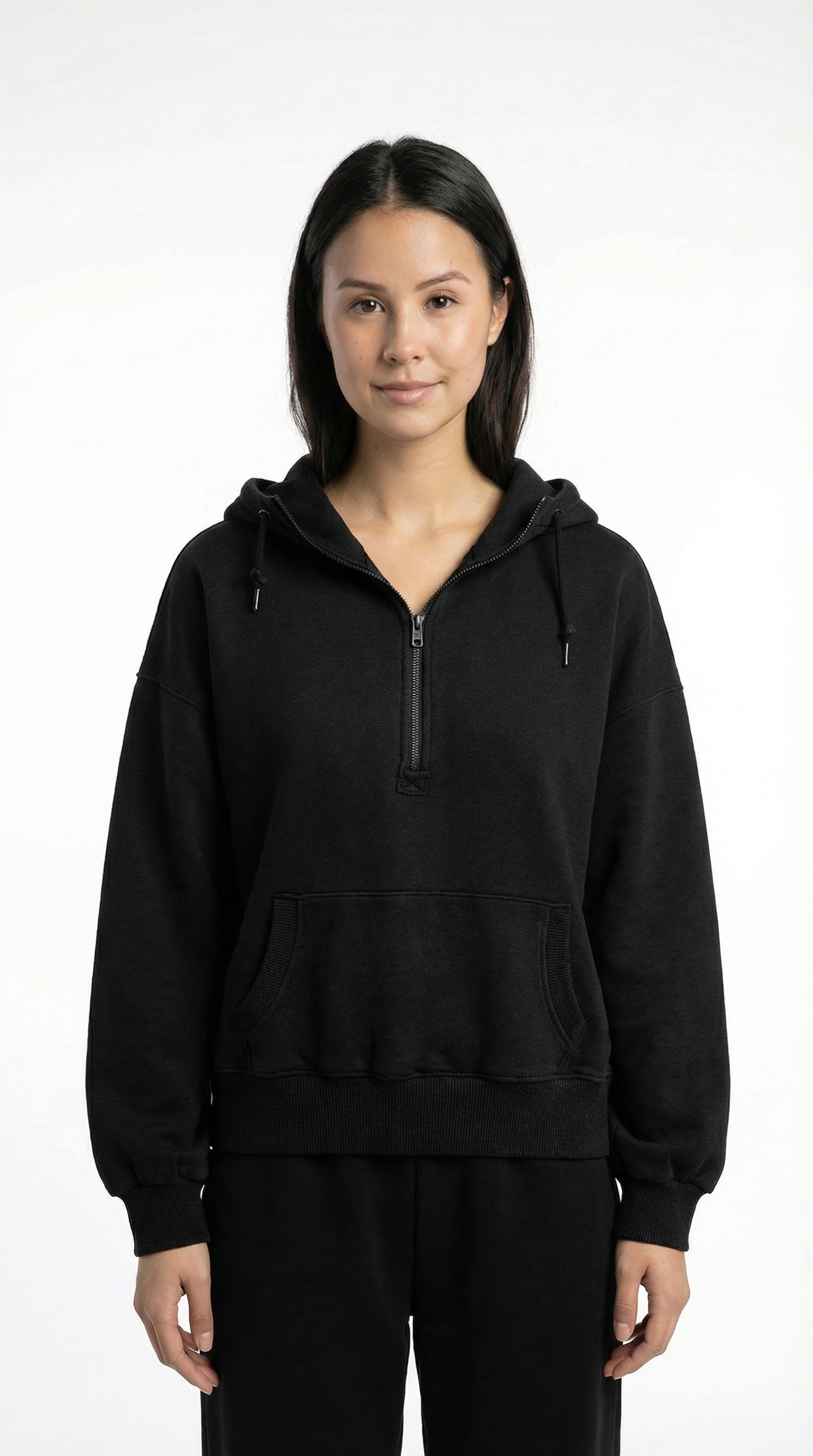 Person wearing a black hoodie with a zipper on a white background