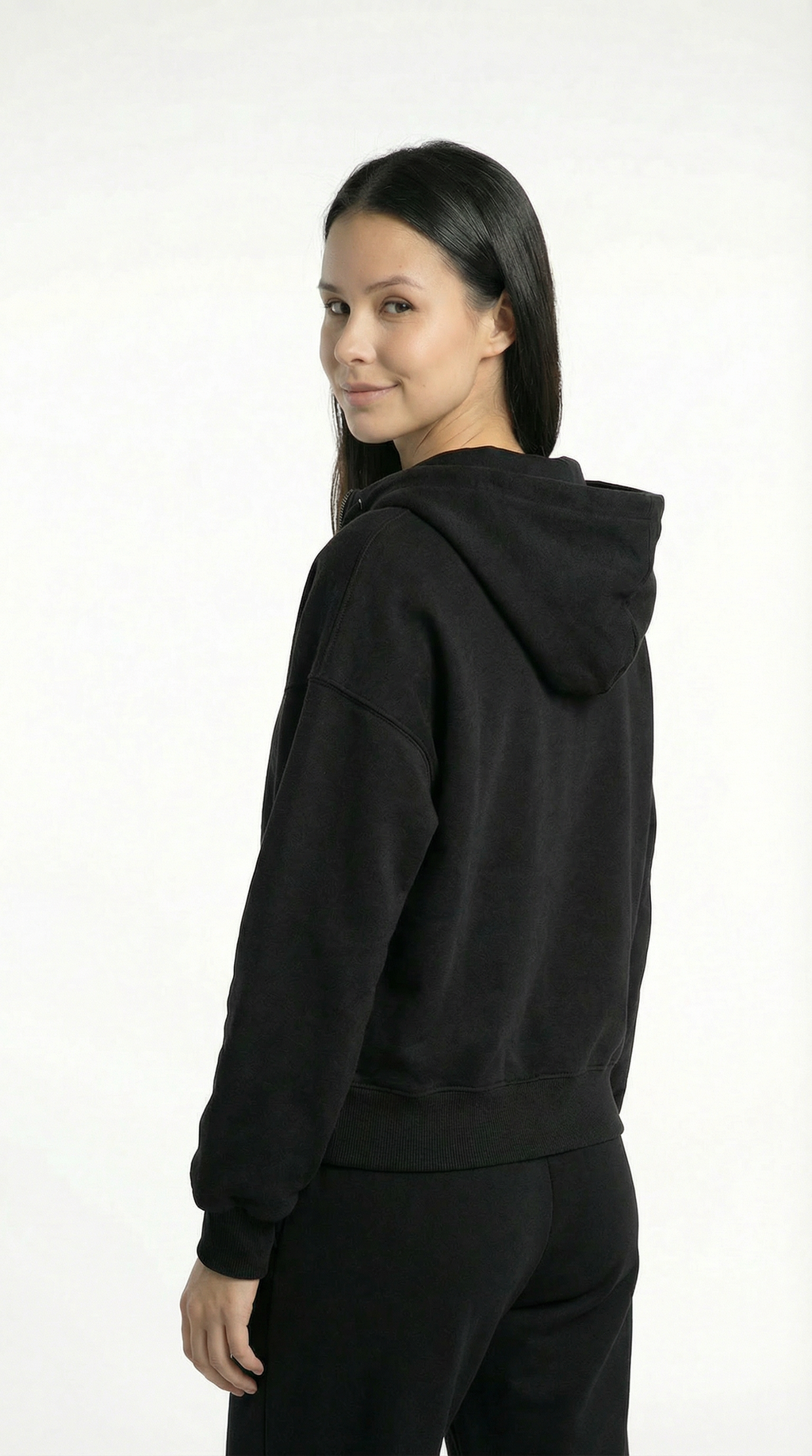 Person wearing a black hoodie on a white background
